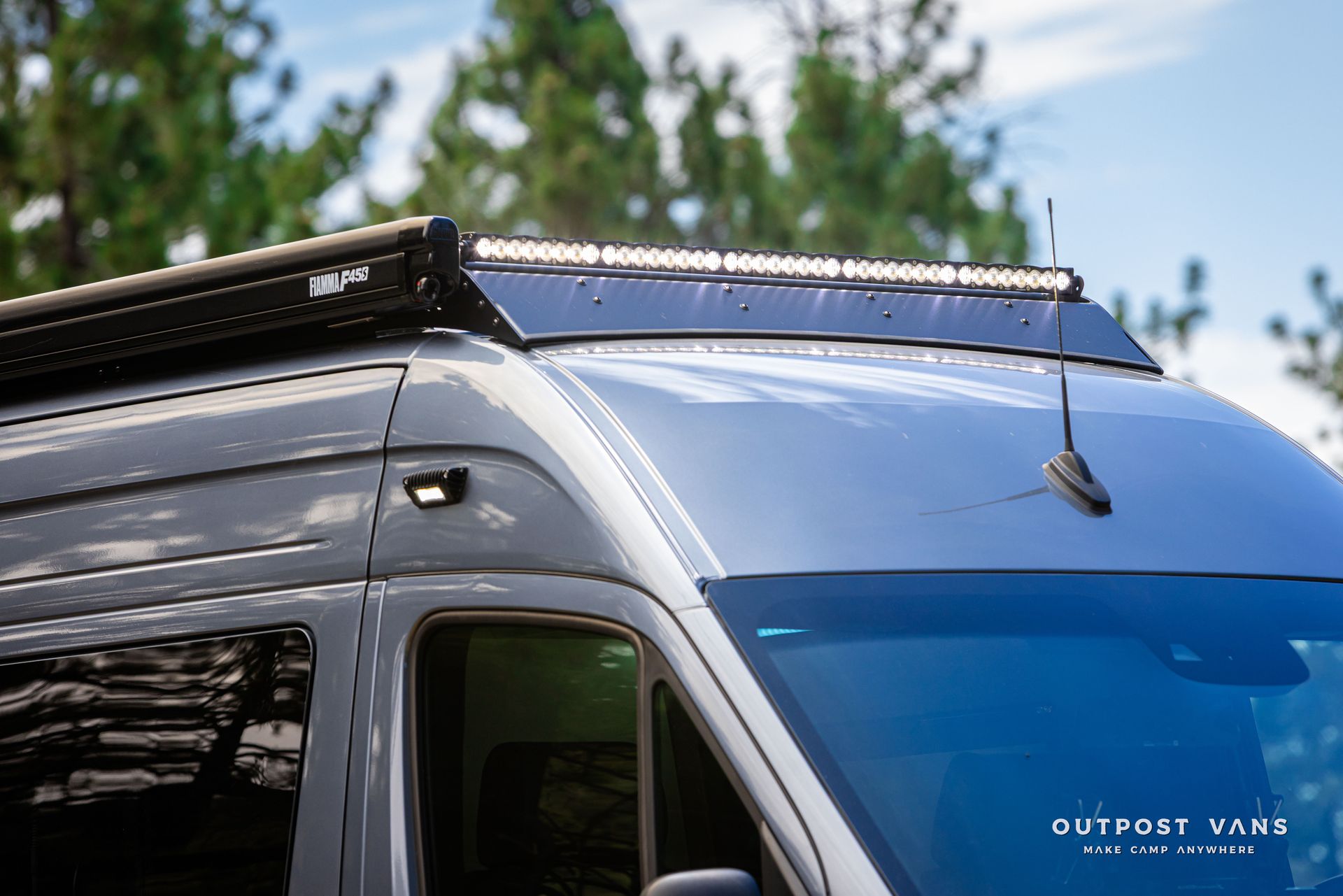 A van with a solar panel on the roof. Outpost vans Sprinter 170 AWD.