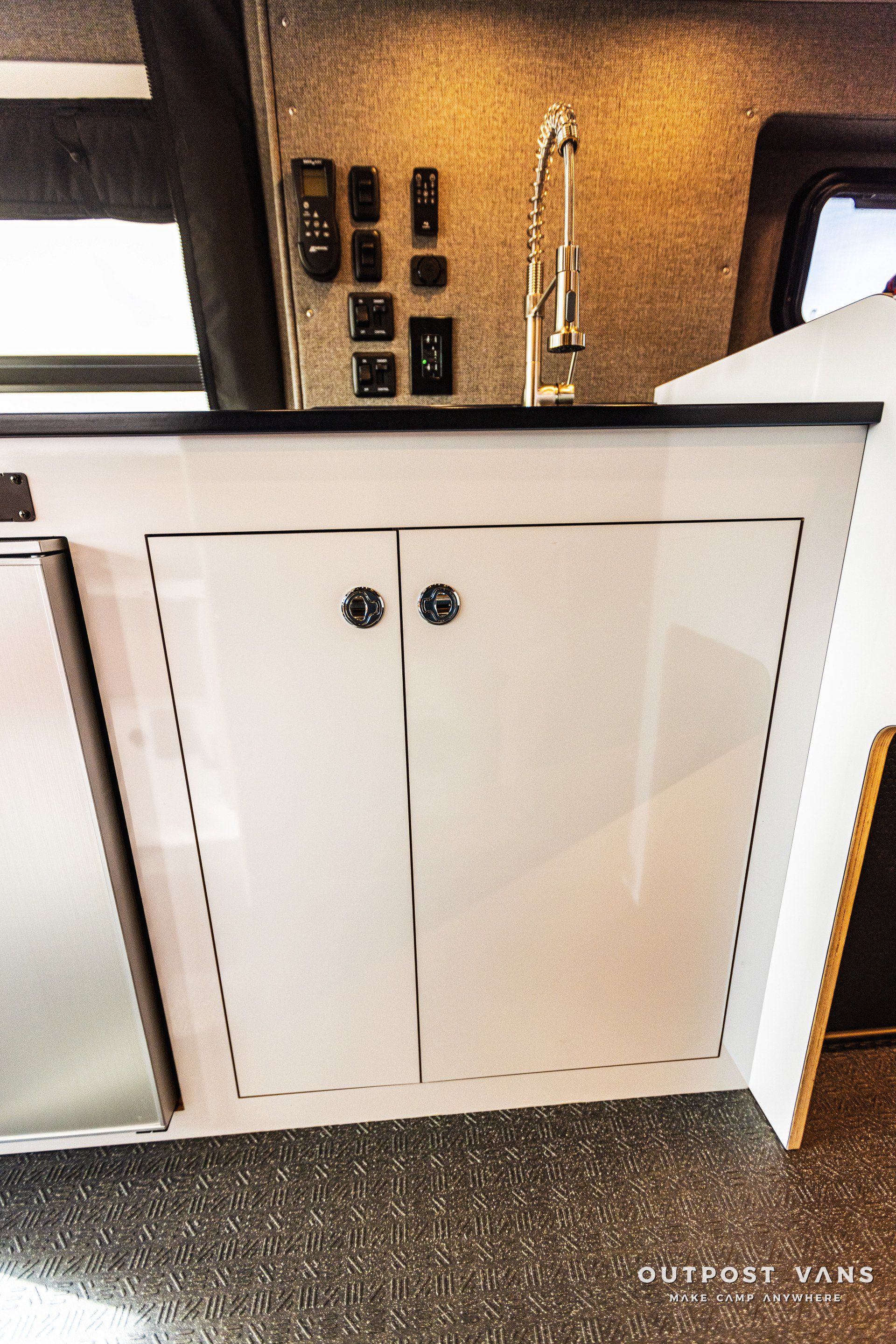 A kitchen with a sink , cabinets , and a faucet.