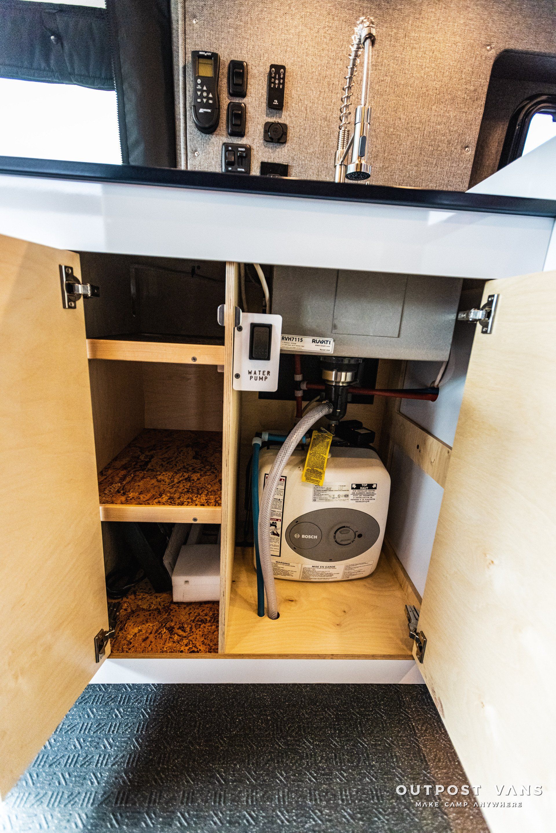 A sink is hidden under a cabinet in a kitchen.