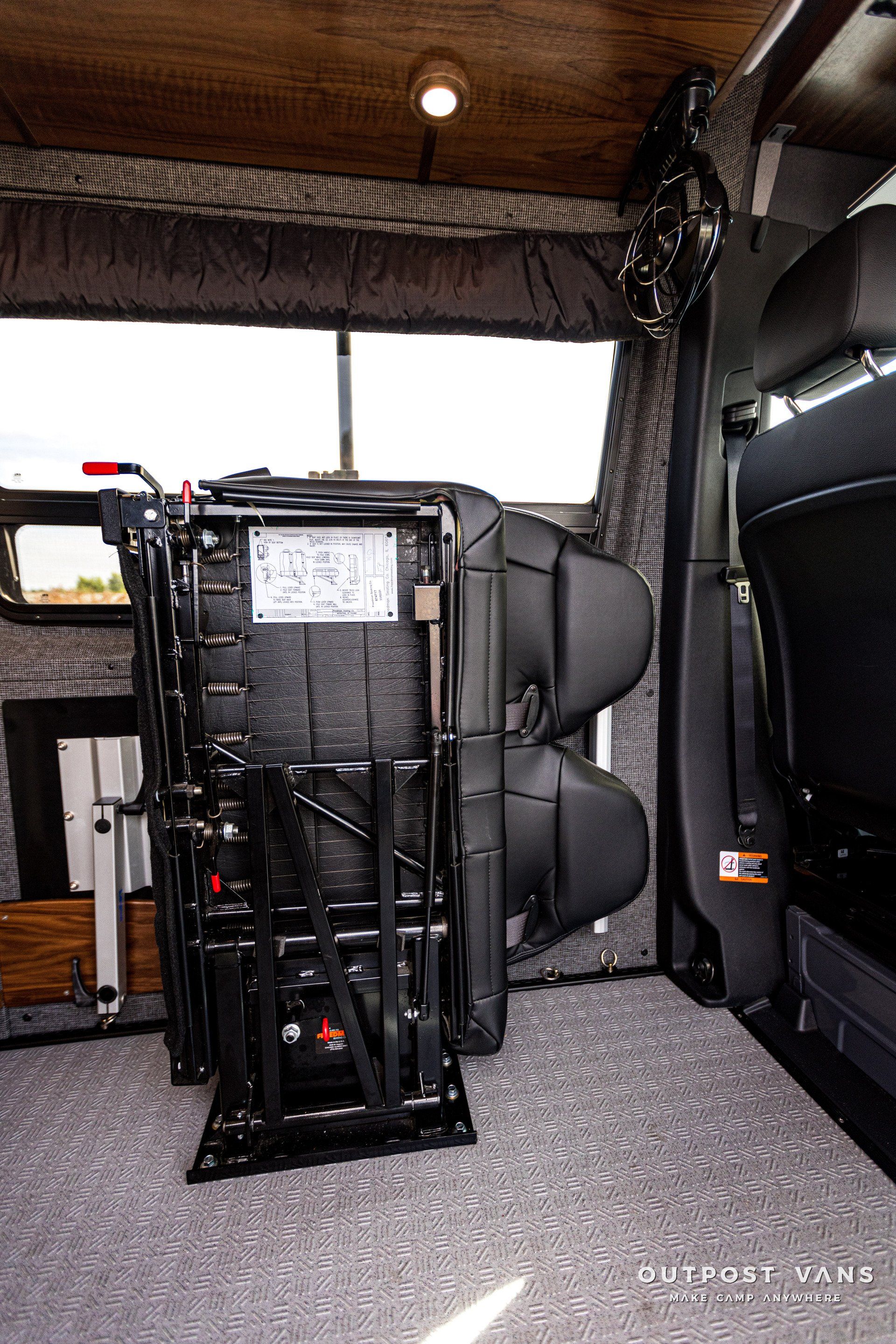 There is a chair in the back of a van.