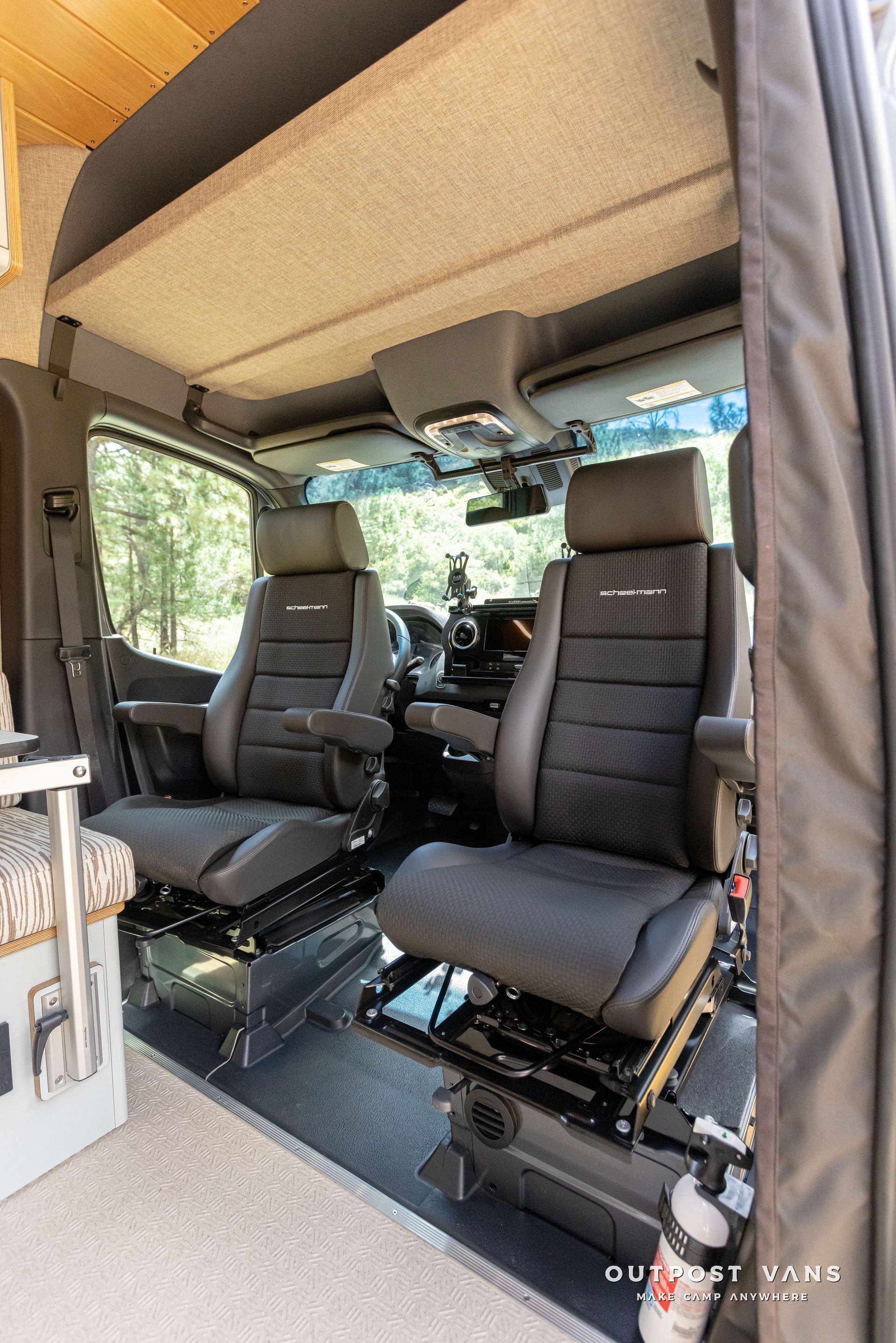 There are two seats in the back of a van. Outpost vans Sprinter 170 AWD.