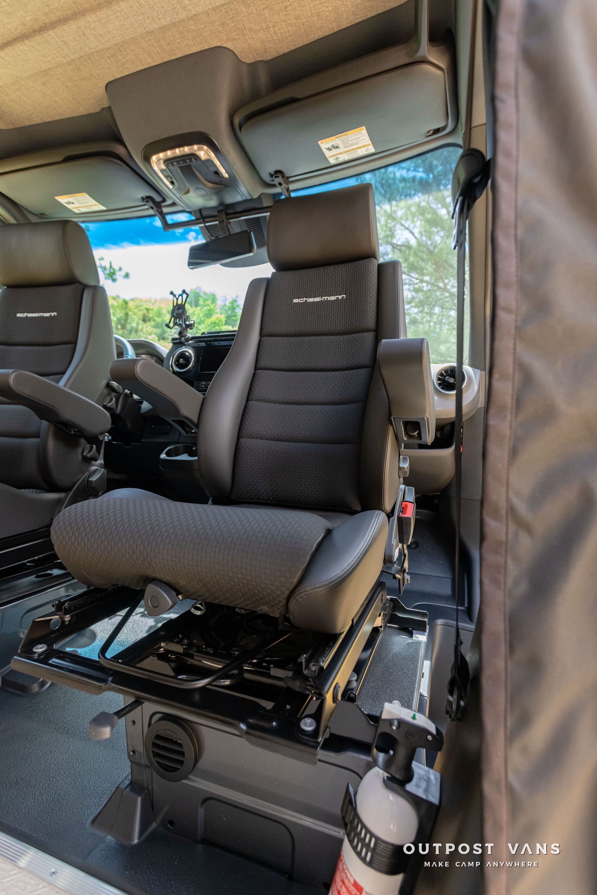 A car with a fire extinguisher in the back seat. Outpost vans Sprinter 170 AWD.