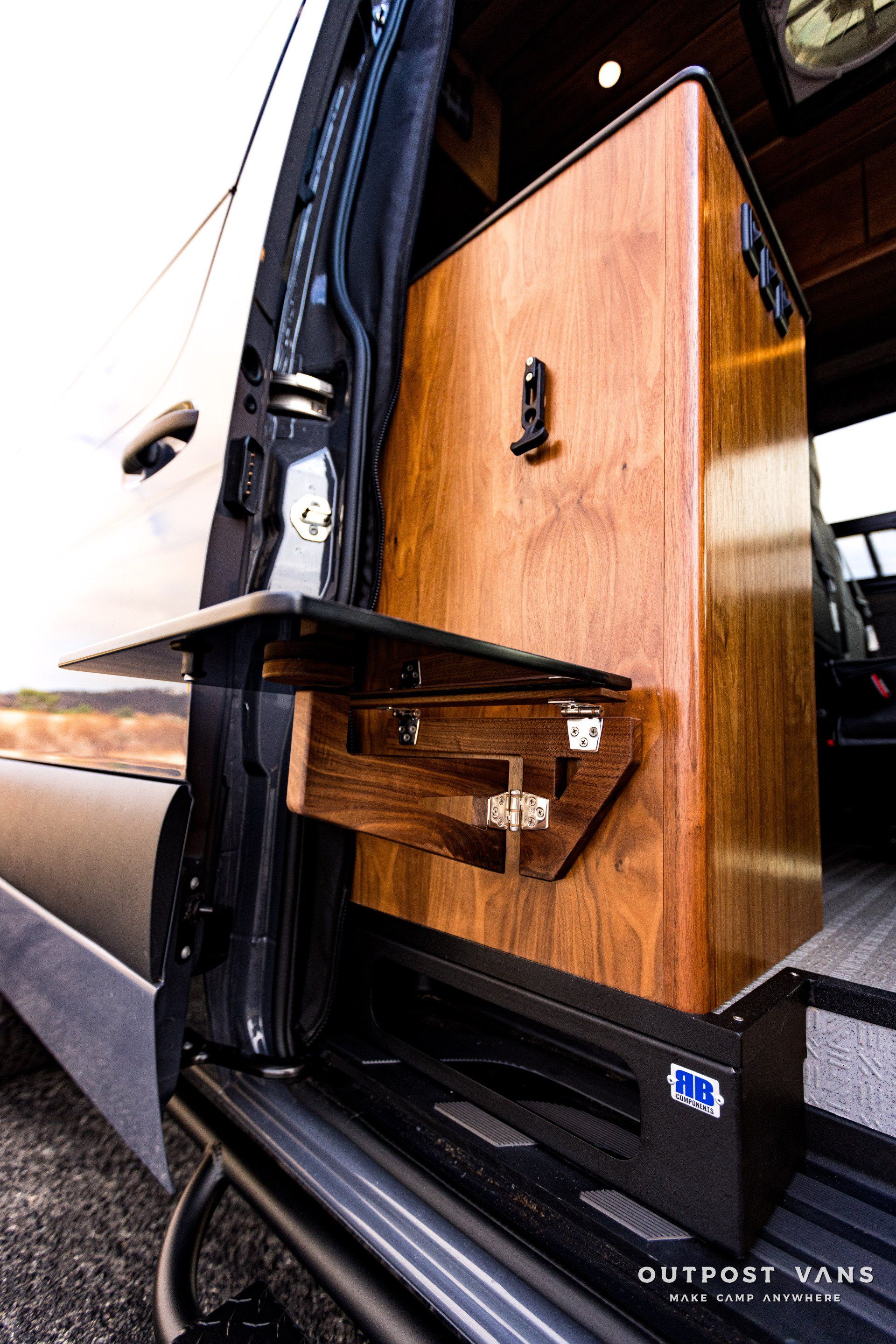 A van with a wooden drawer in the back of it.