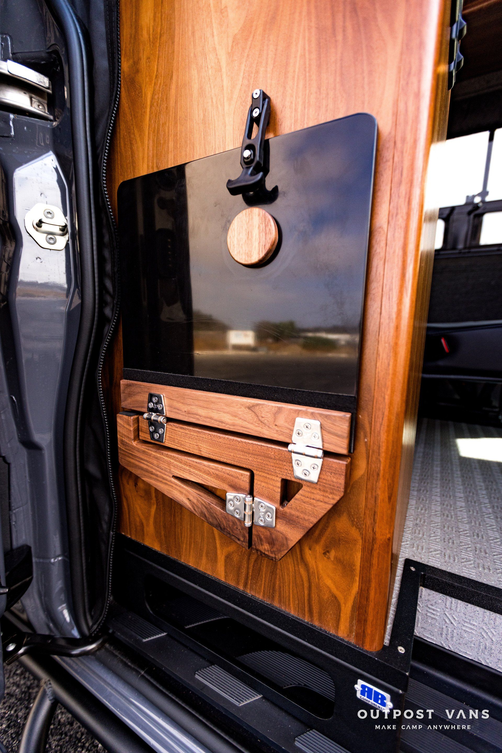 A close up of a wooden box on the side of a van.
