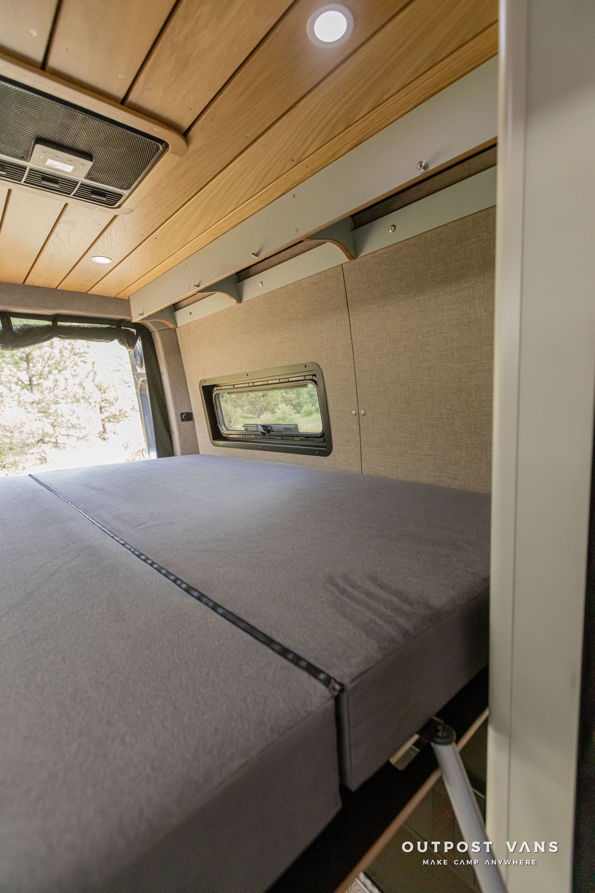 There is a bed in the back of a van.