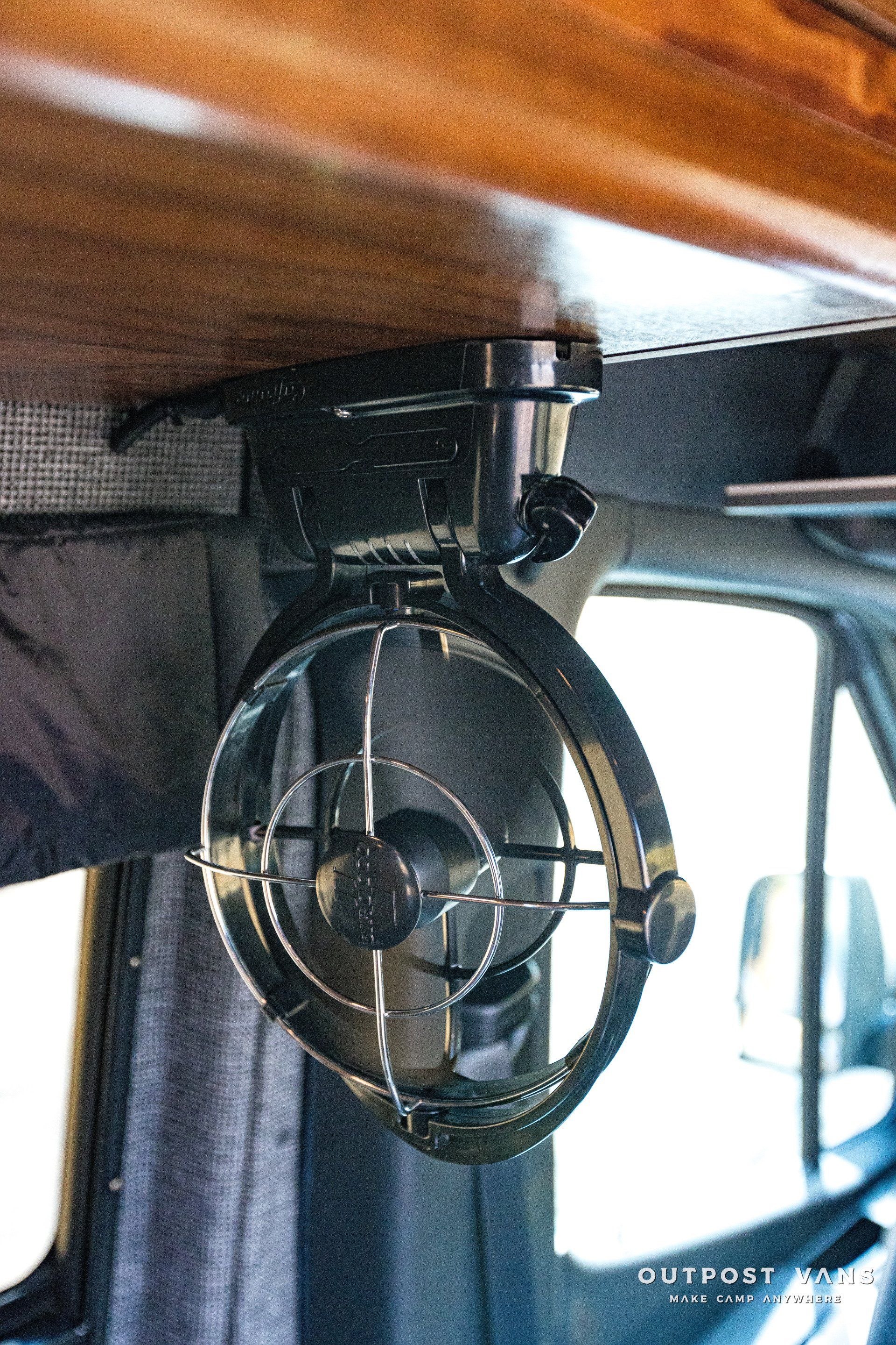 A fan is hanging from the ceiling of a vehicle