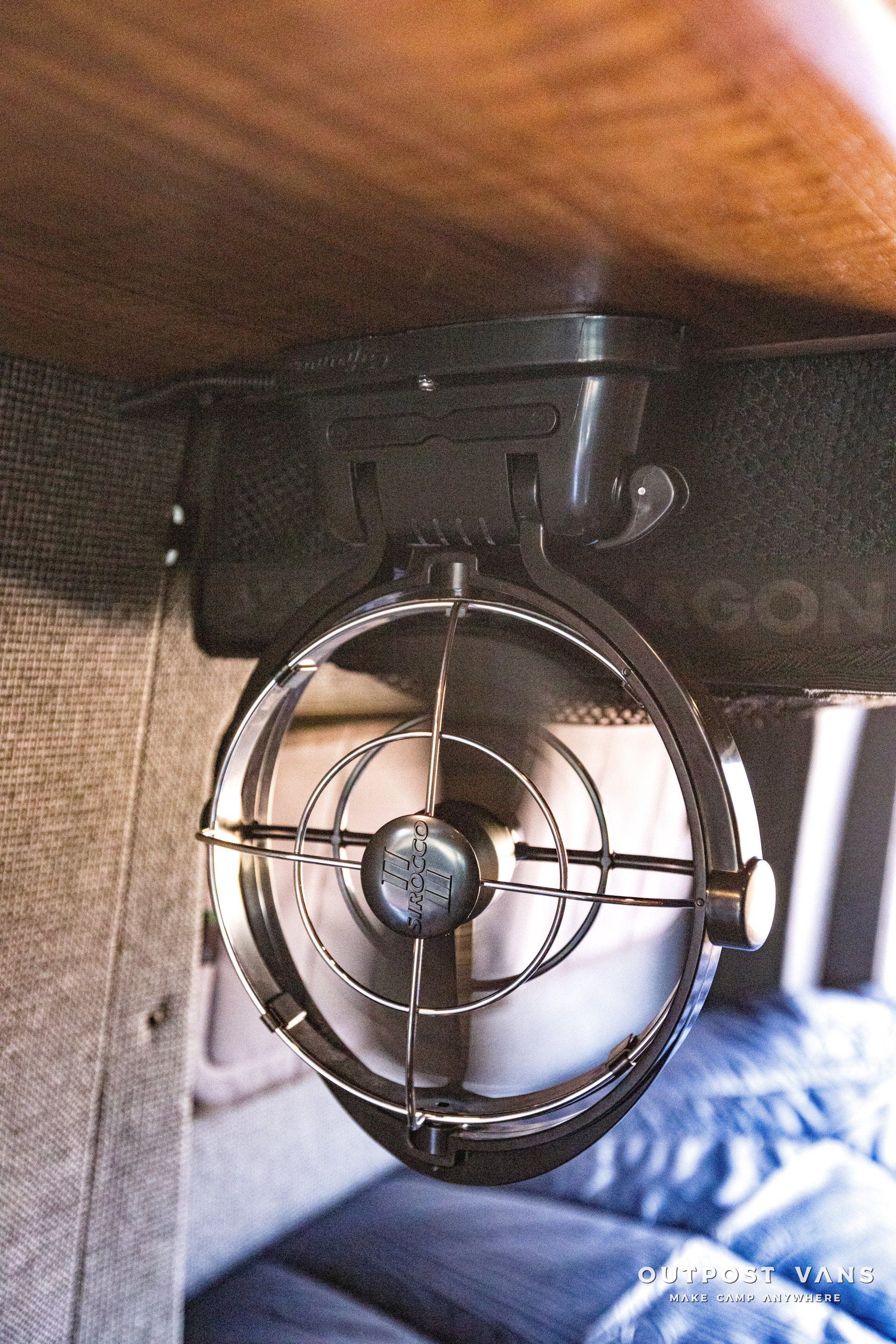 A fan is hanging from the ceiling of a room.