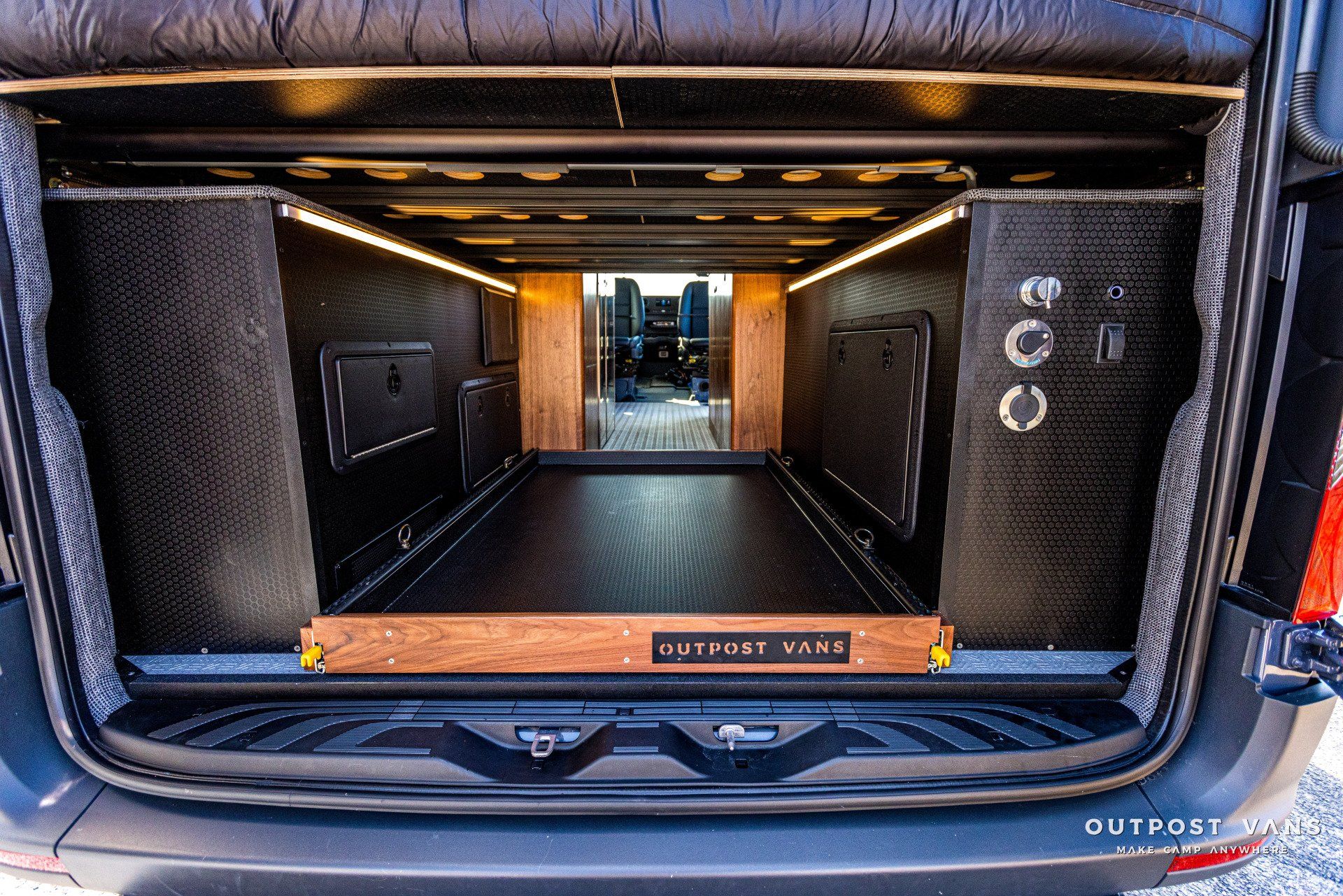The back of a van with the door open and the trunk open.