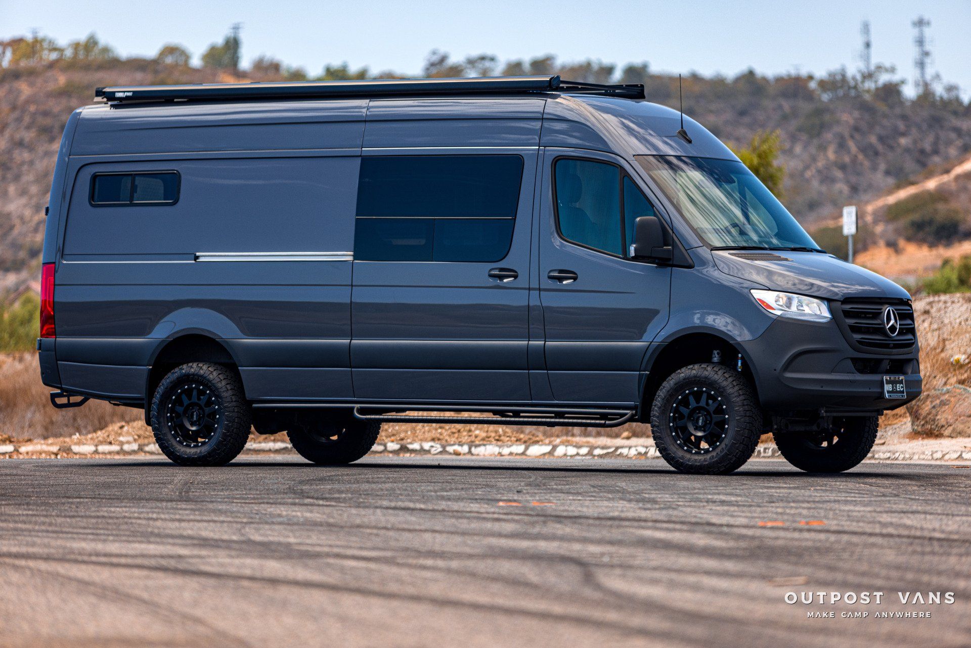 A gray van is parked on the side of the road.