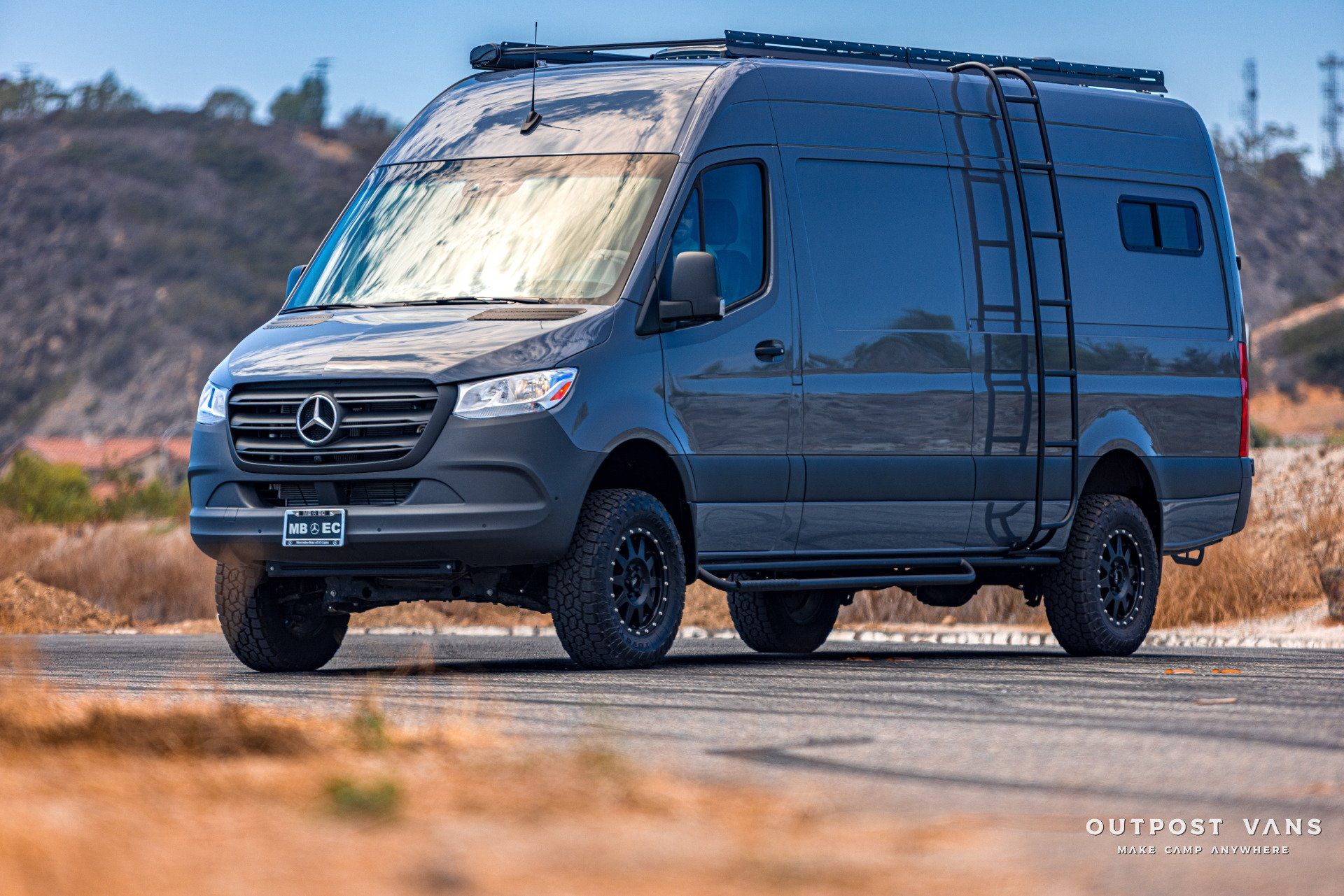 A mercedes sprinter van is parked on the side of the road.