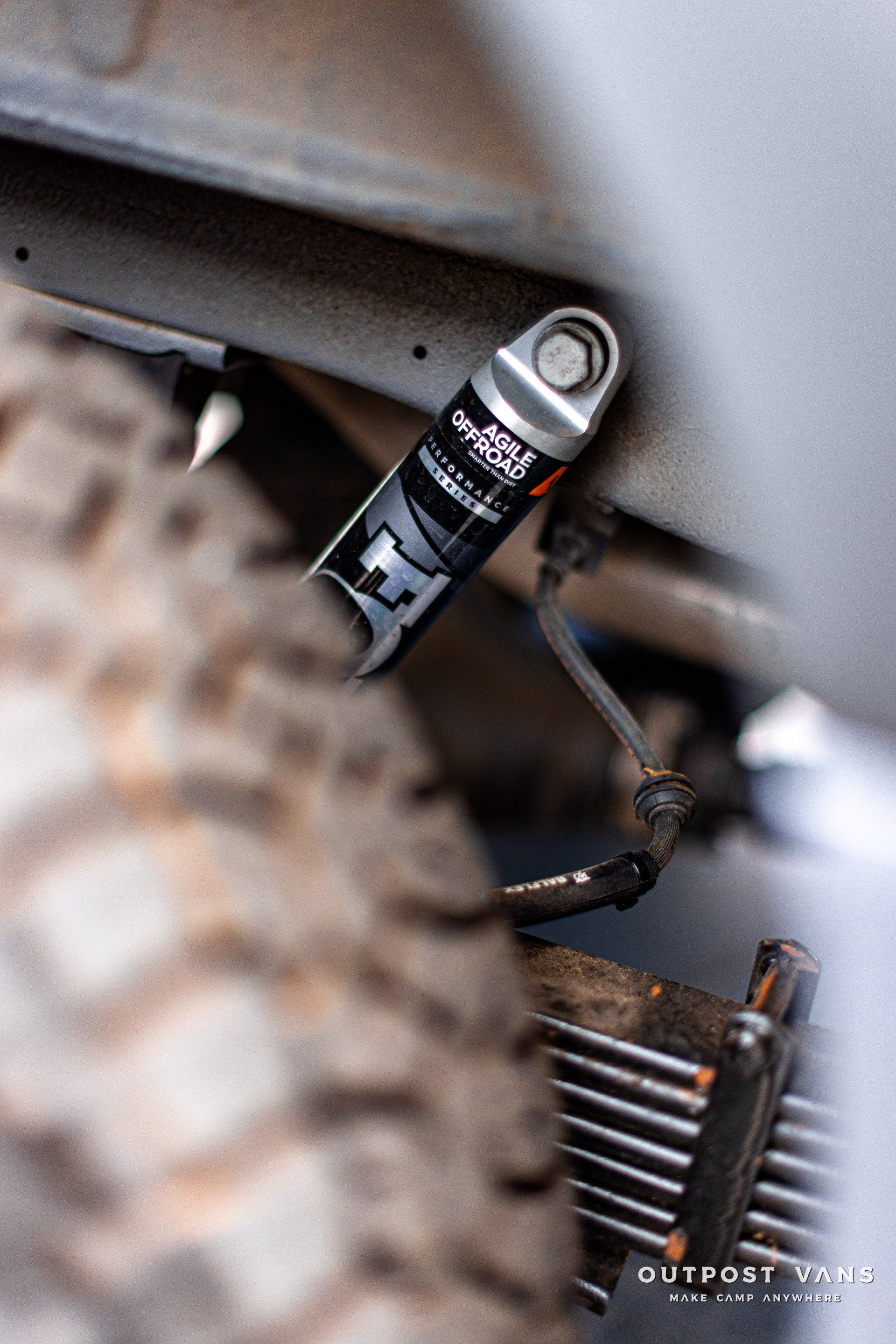 A close up of a shock absorber on a vehicle.