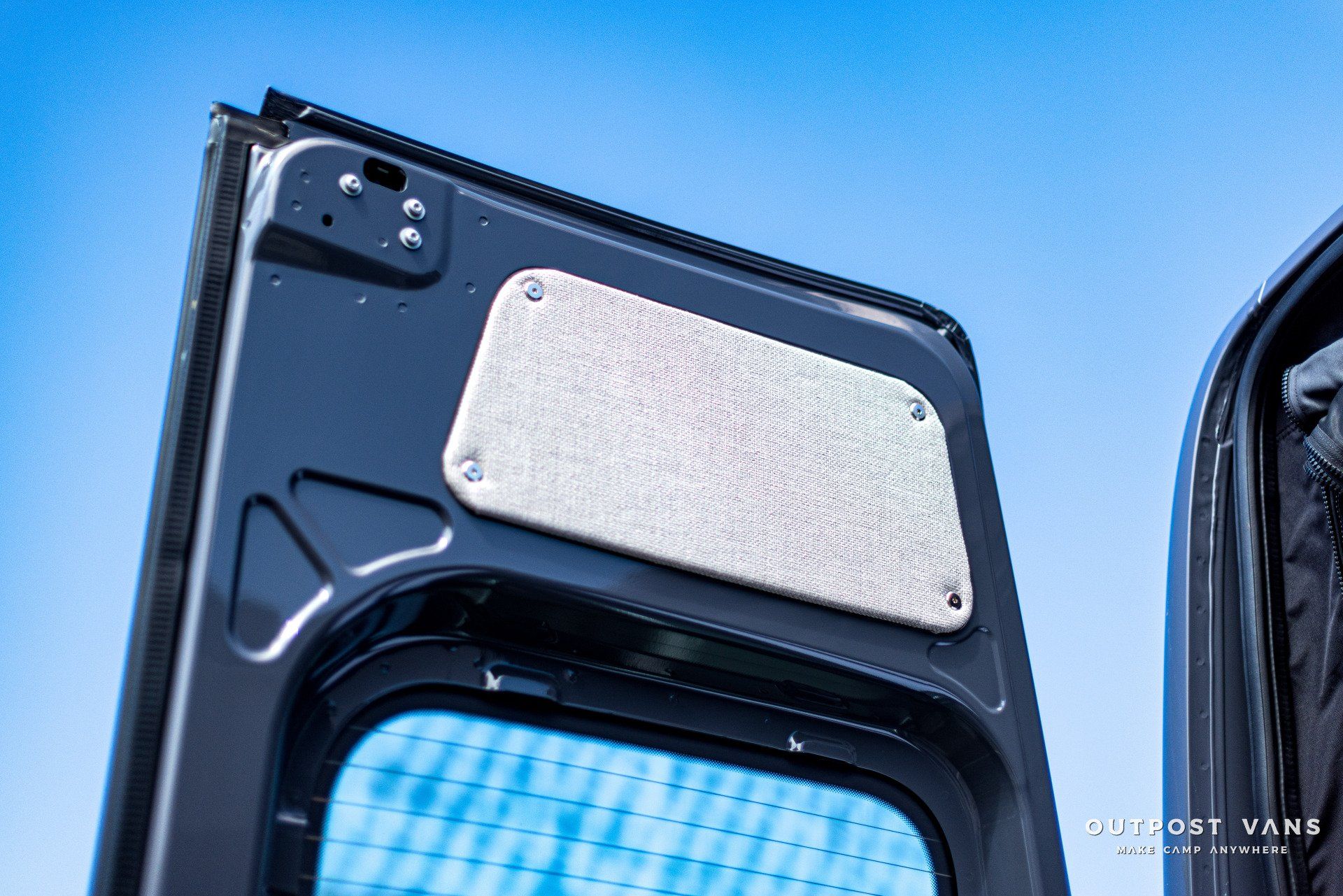 a close up of a van door with a blue sky in the background .