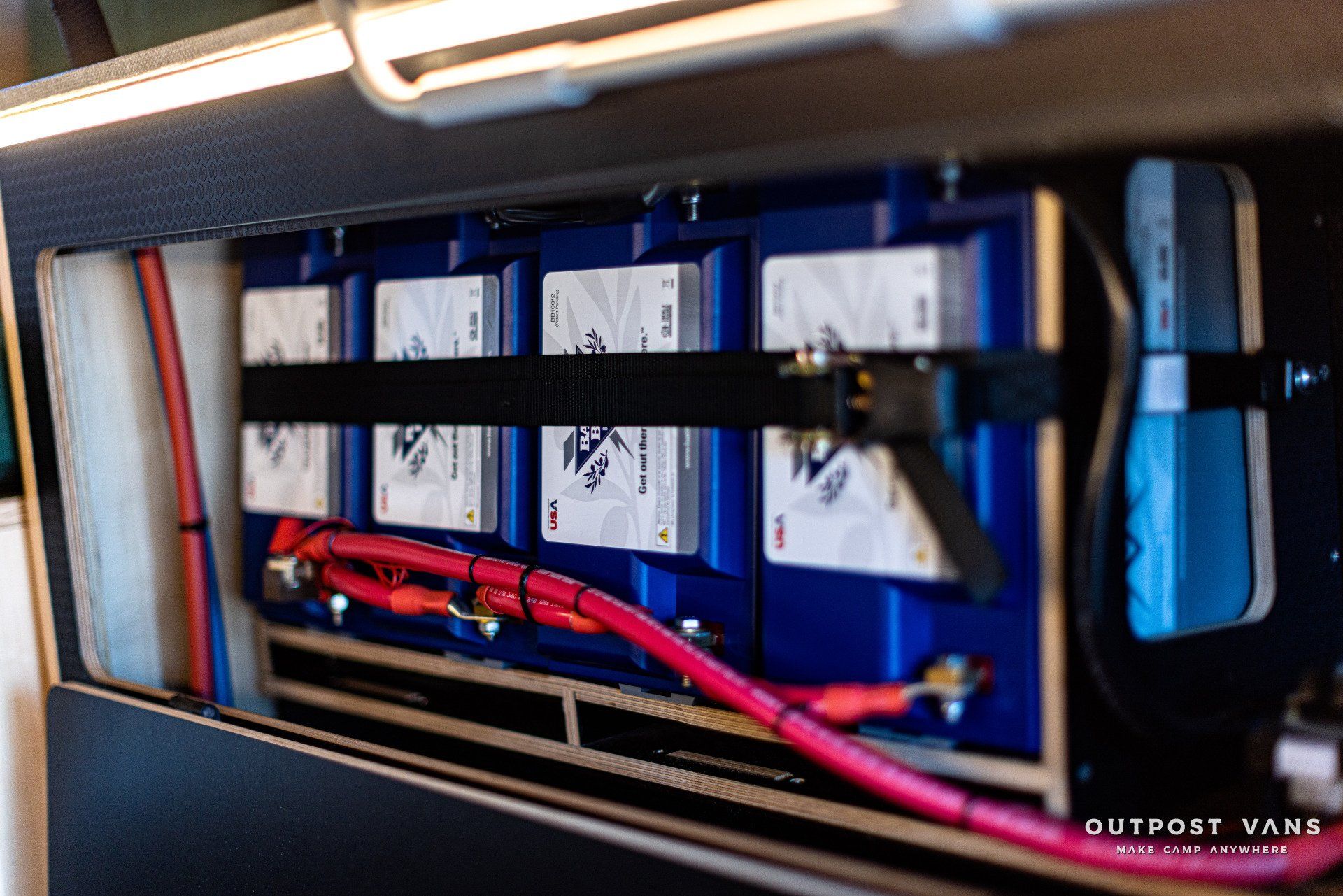 a bunch of blue batteries are sitting inside of a van