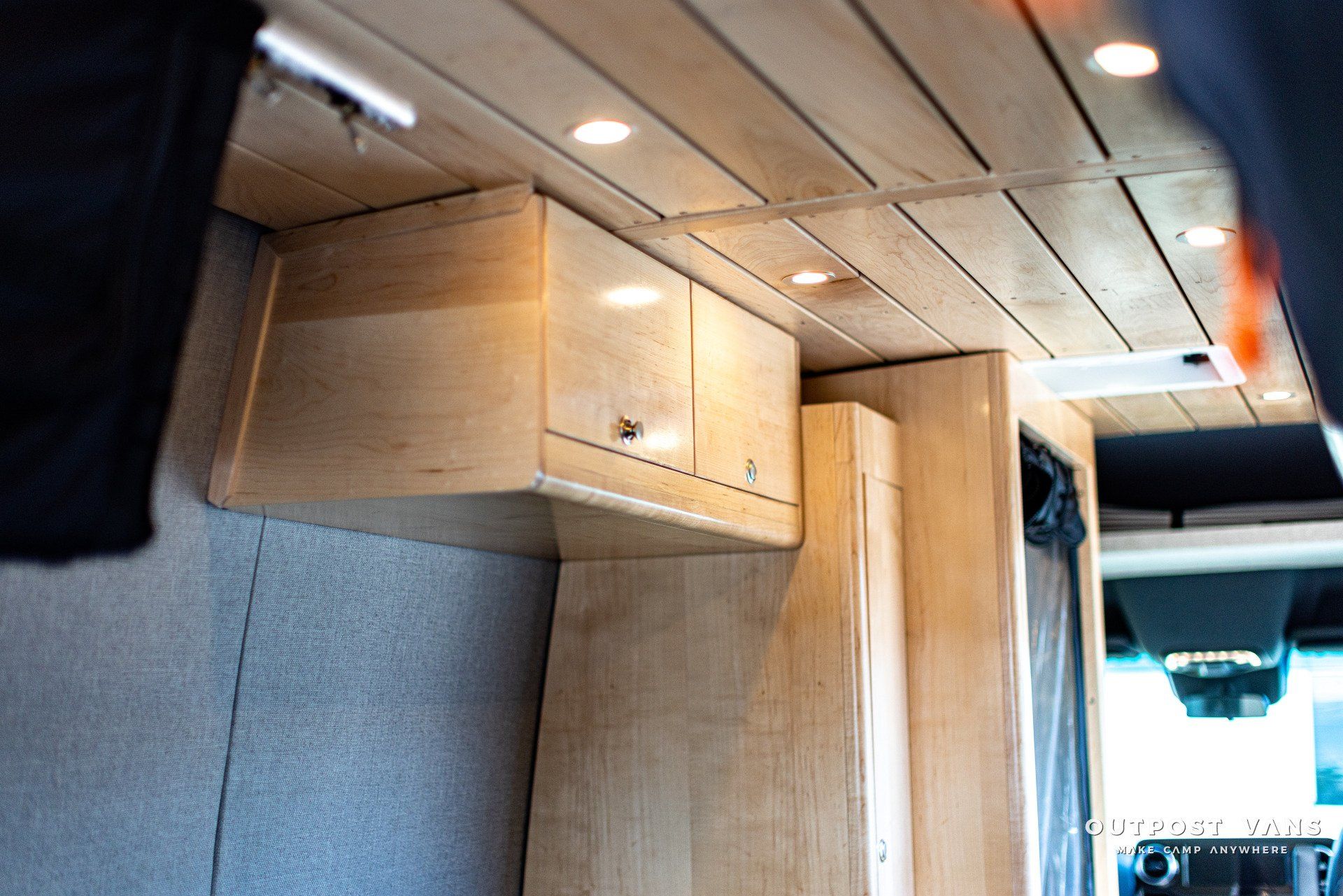 A van with wooden cabinets and a wooden ceiling.