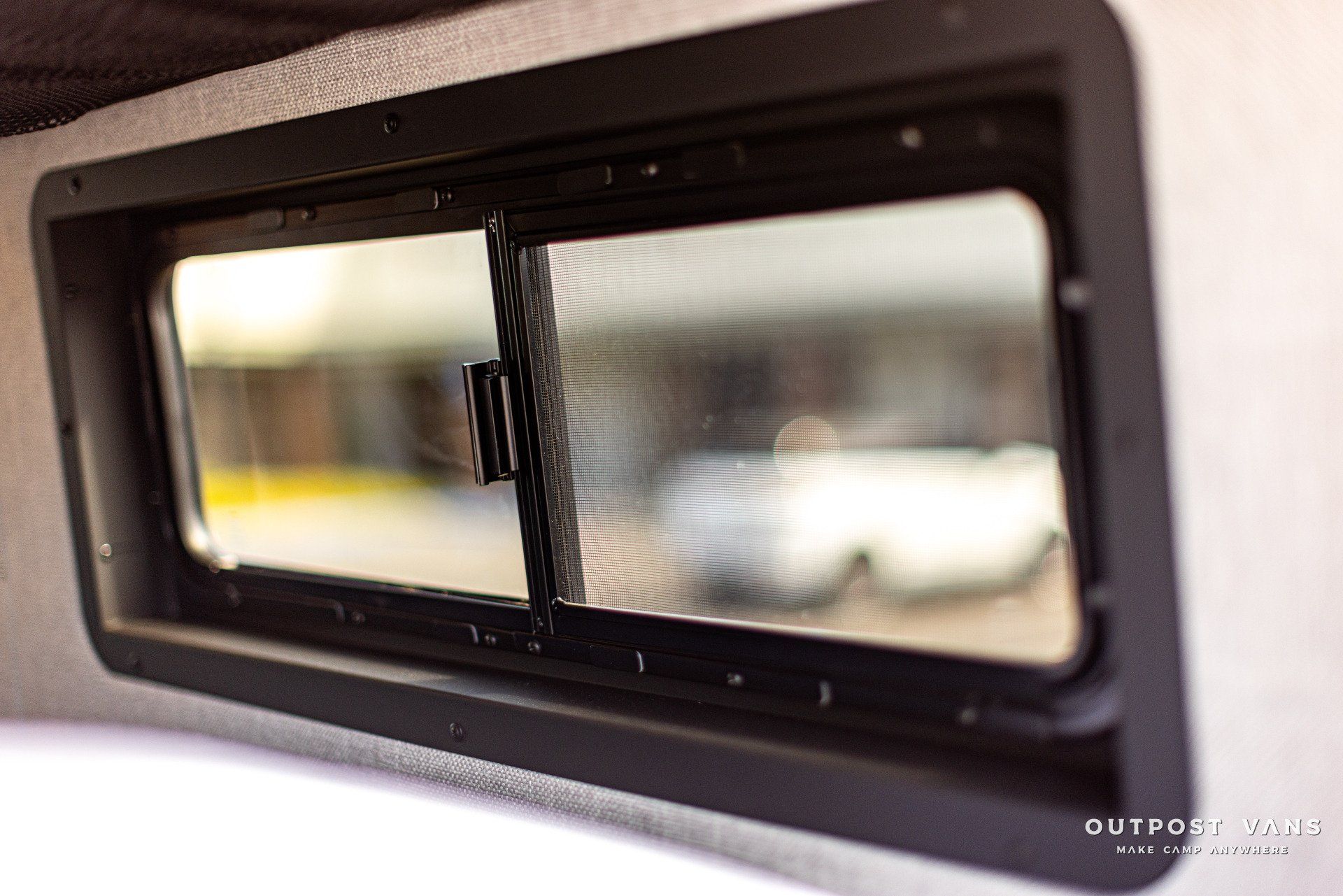 a close up of a window with a reflection of a car in it .