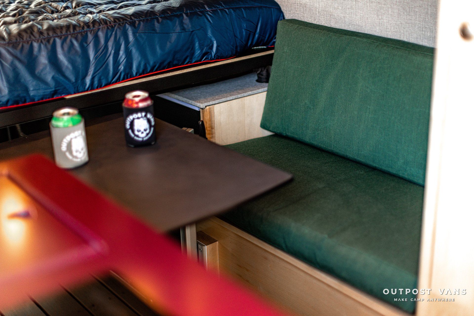 A table with two cans of beer on it in a camper.