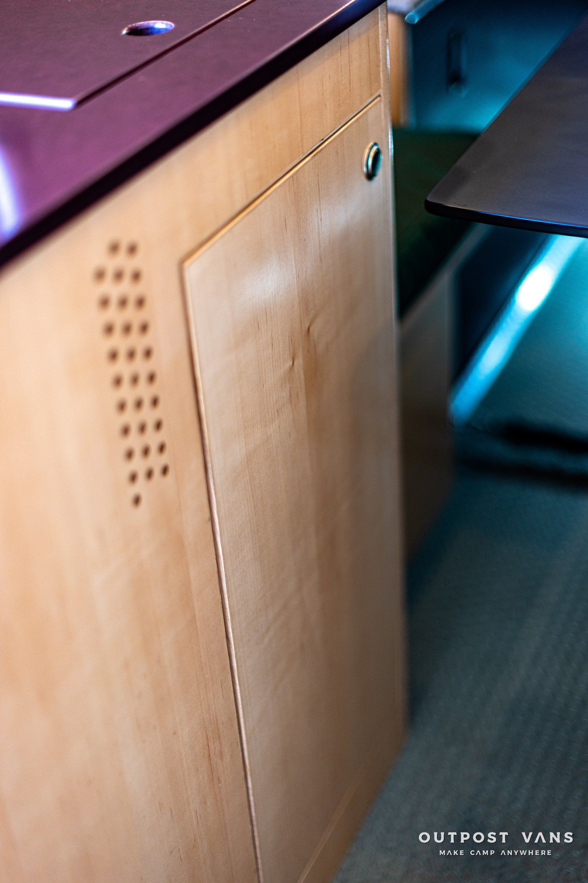 A wooden cabinet with the word outport vans on it