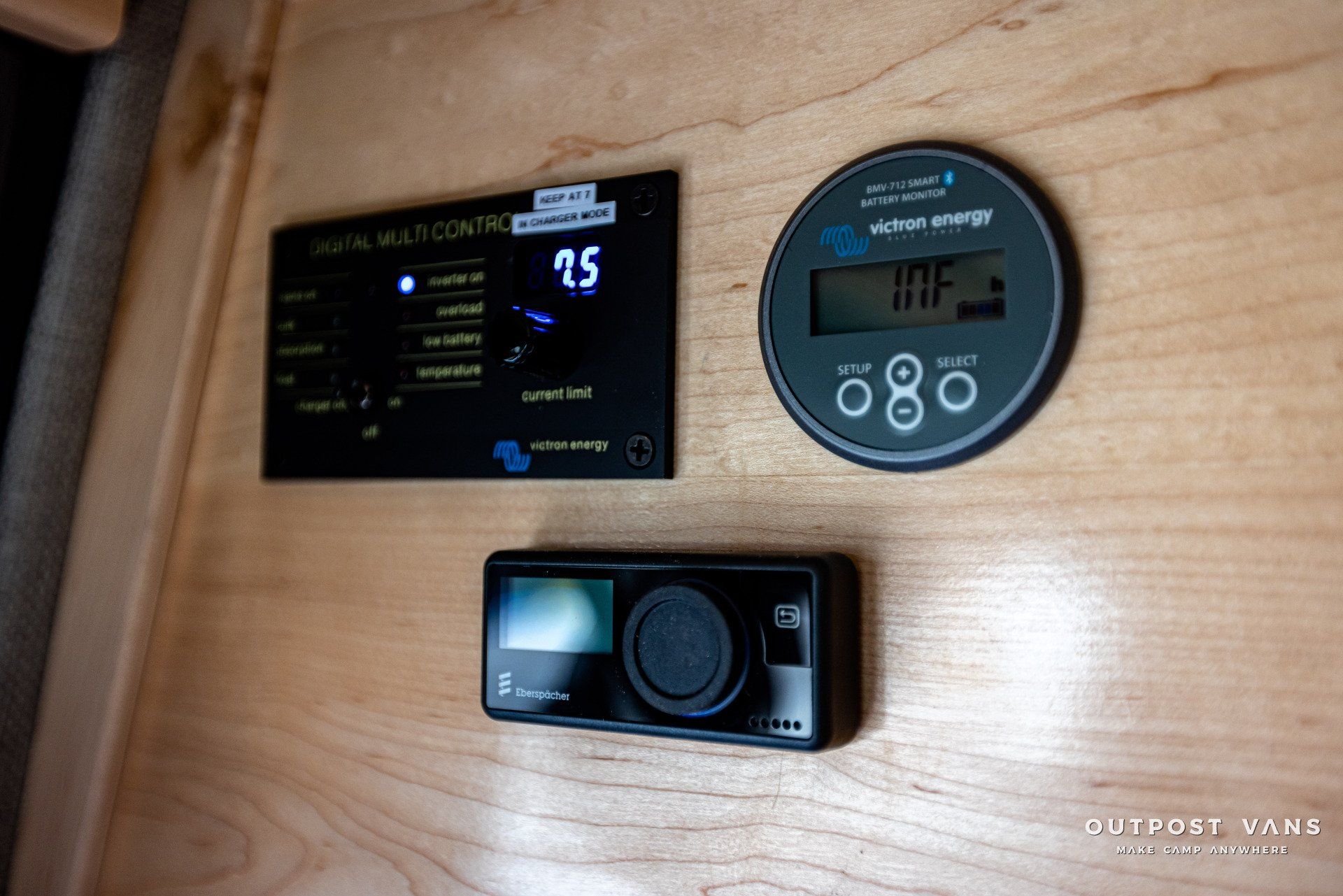 A wooden wall with a thermostat and a clock on it.
