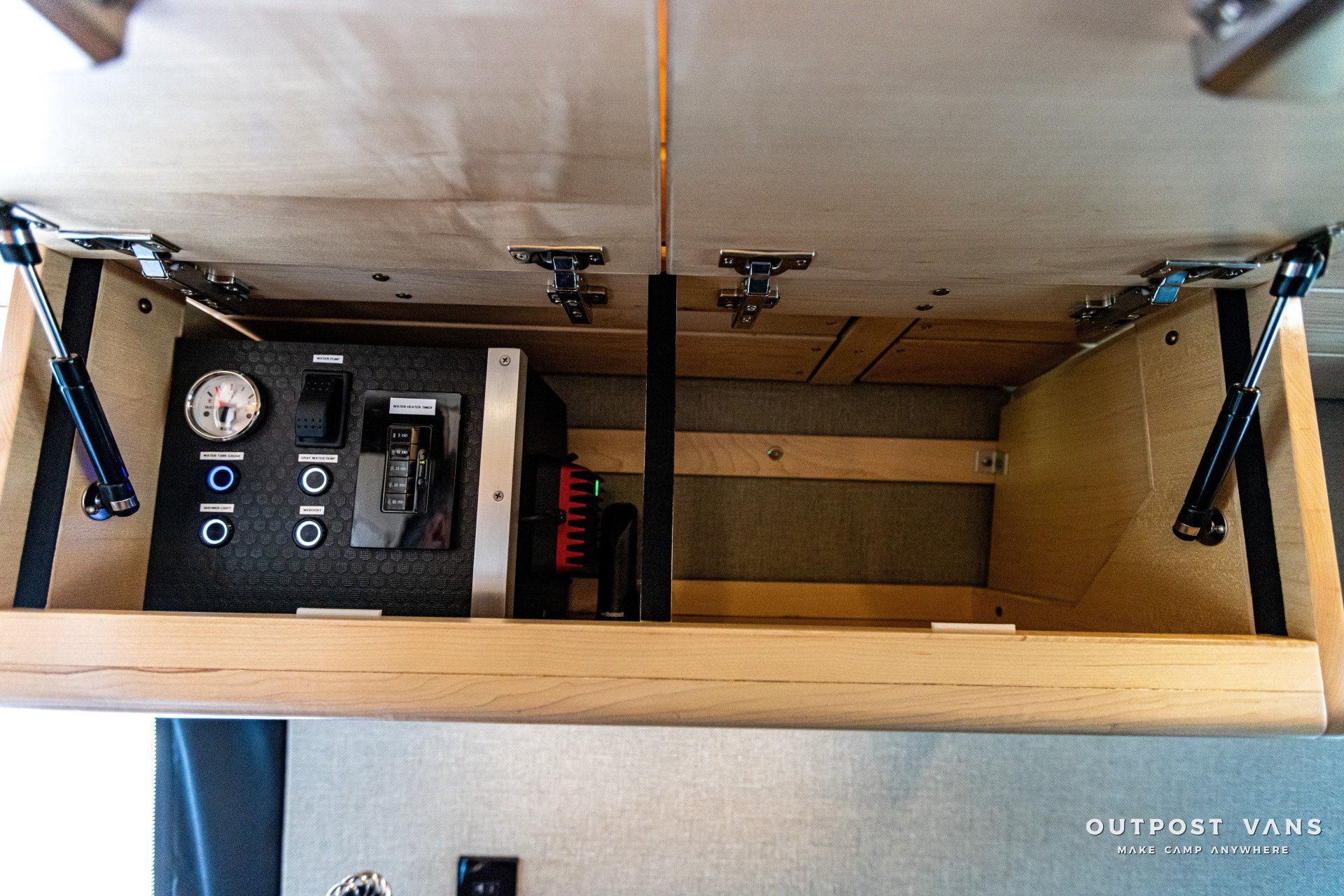 A wooden box with a clock and a switch in it