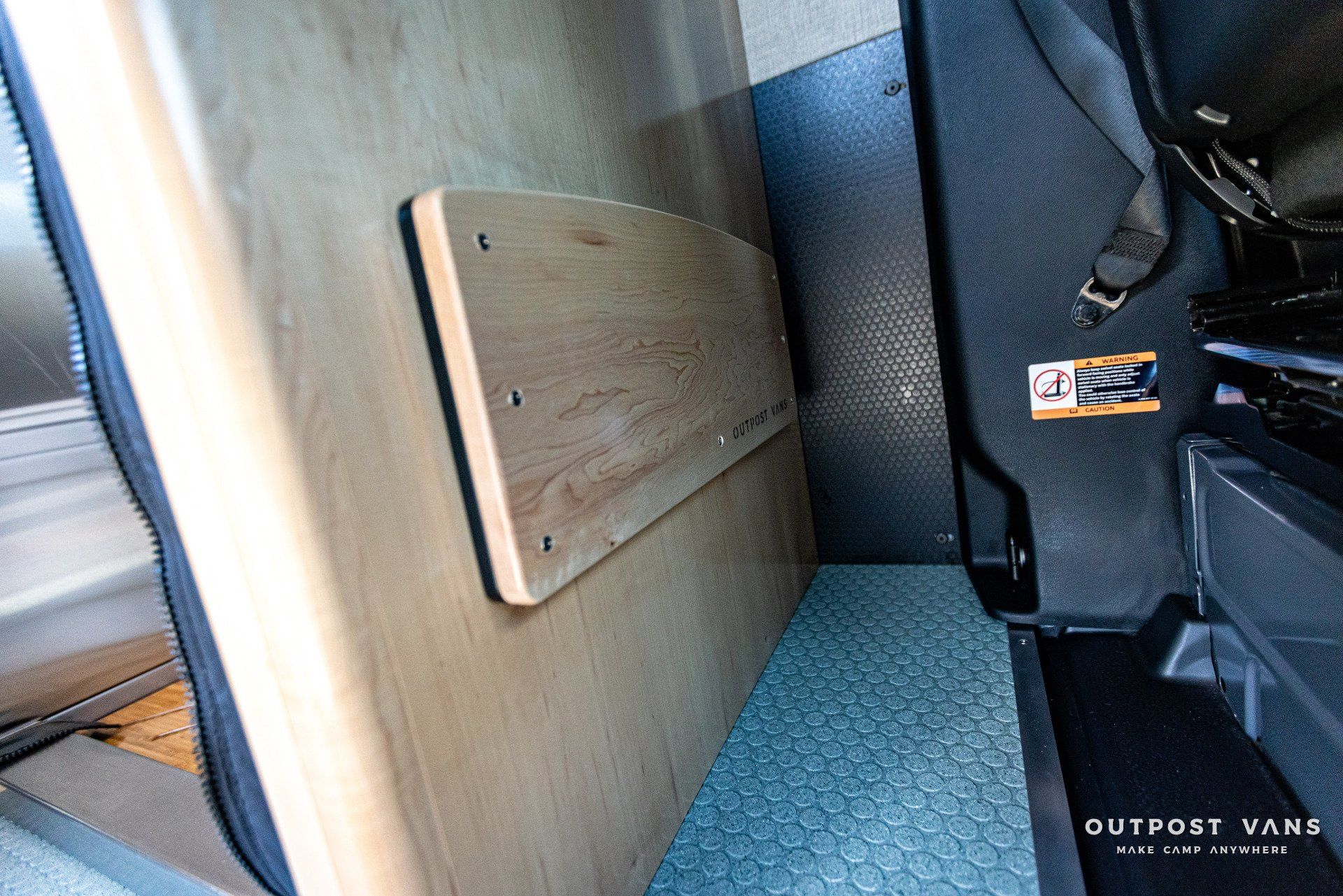 A wooden table is sitting in the back of a van.