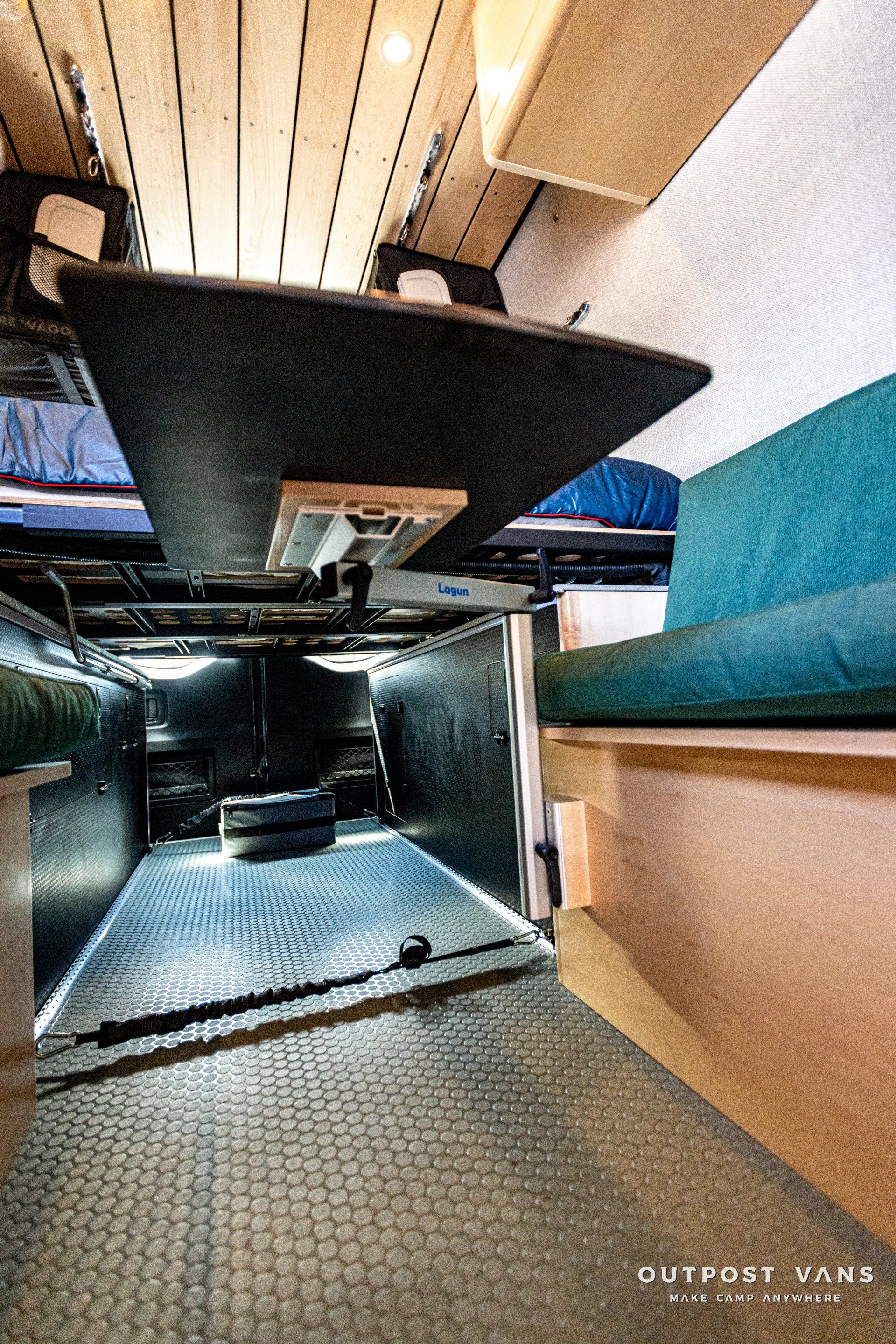 A camper van with a table and a couch in it.