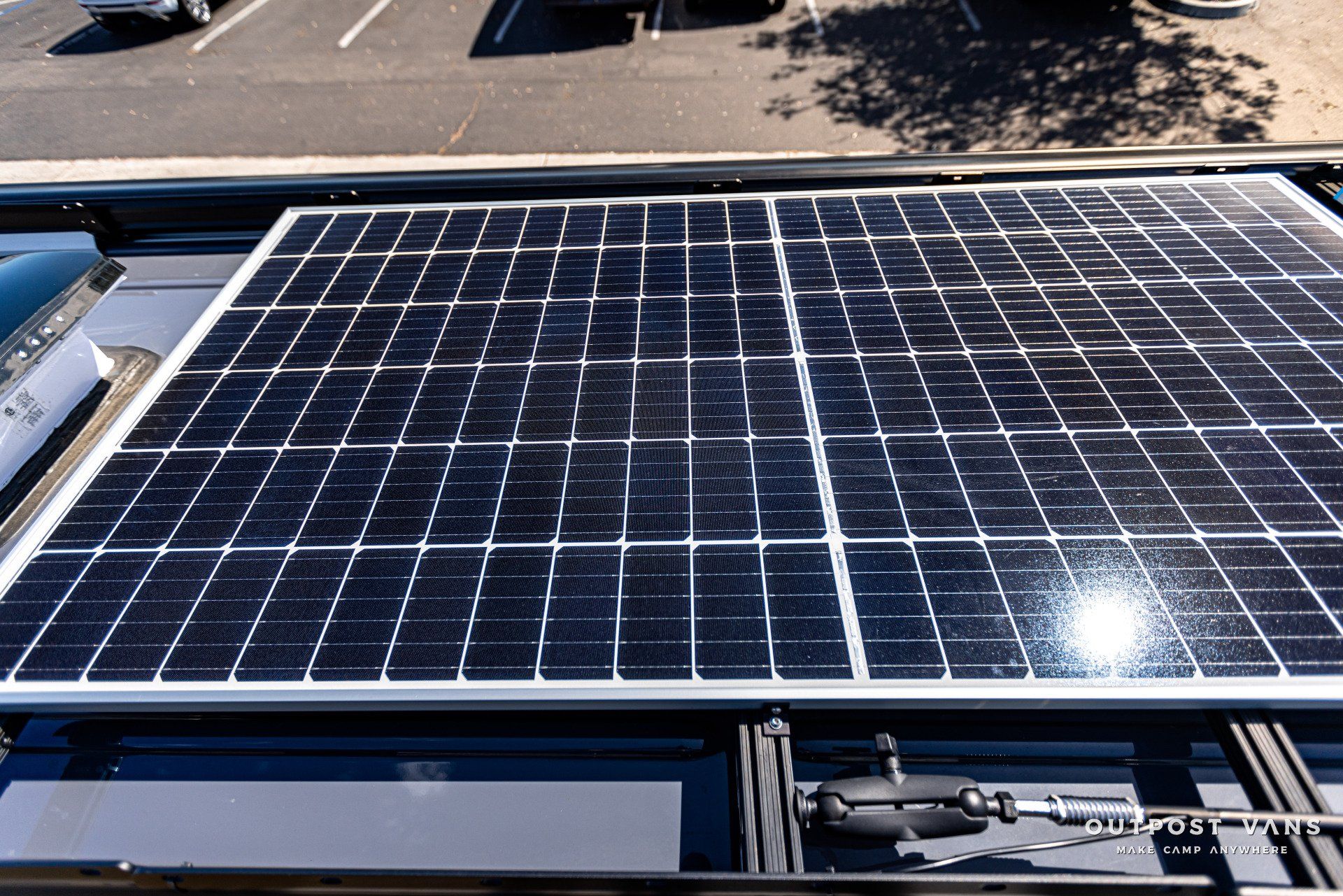A large solar panel is sitting on top of a roof.