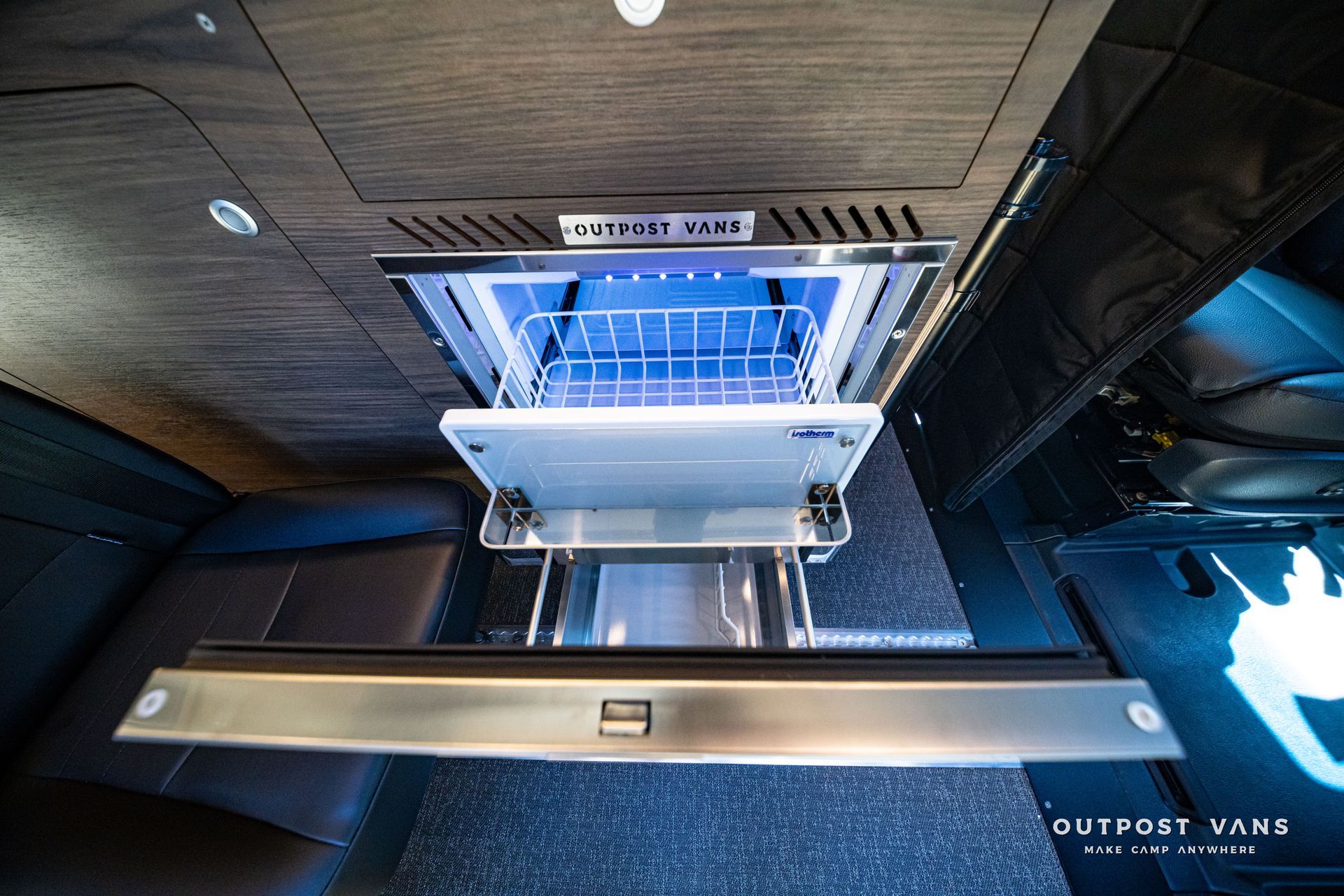 Blue shopping cart elevated in a dark industrial space with ceiling vent and metal platform