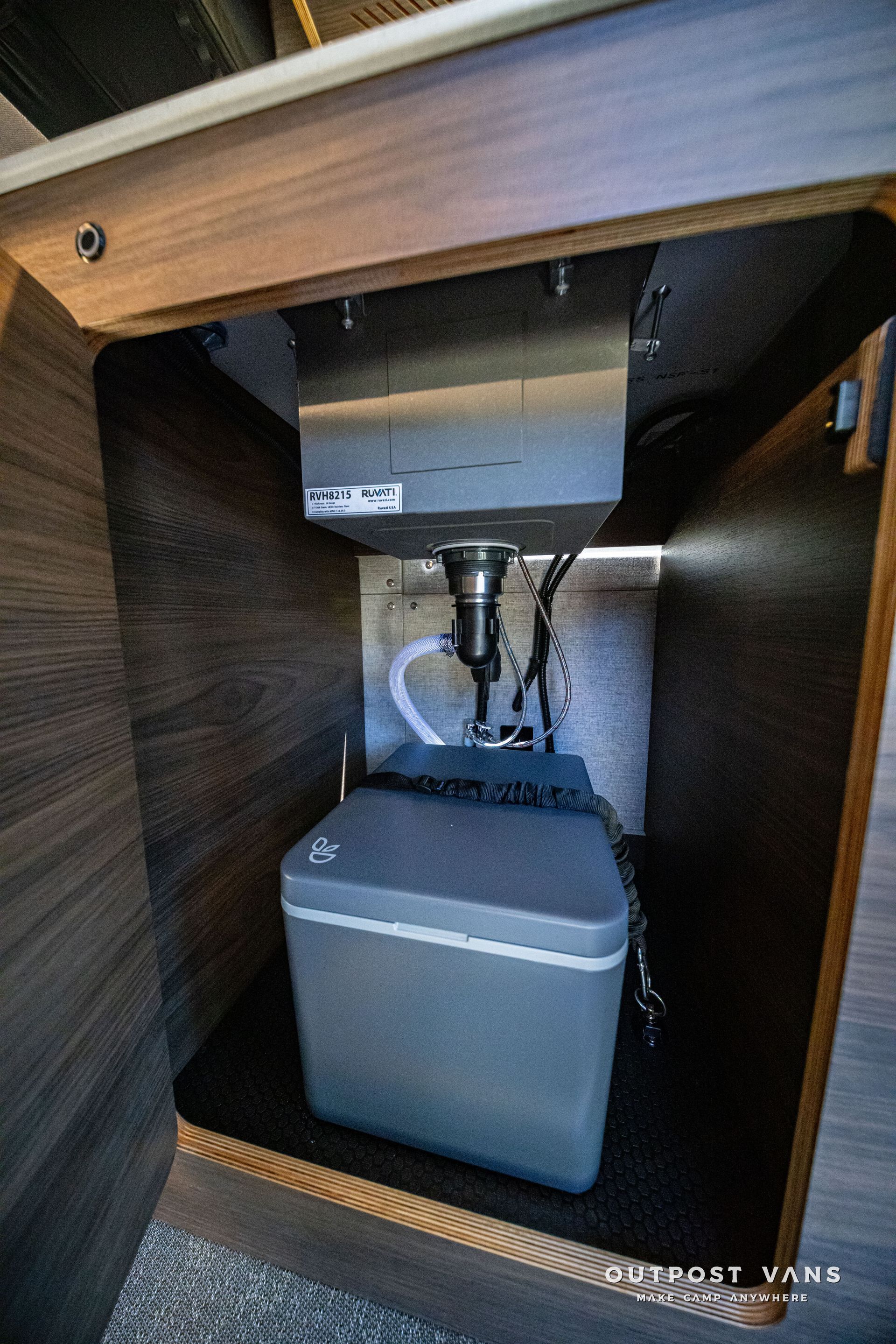 Under-sink cabinet with a grey water filtration system and connected pipes
