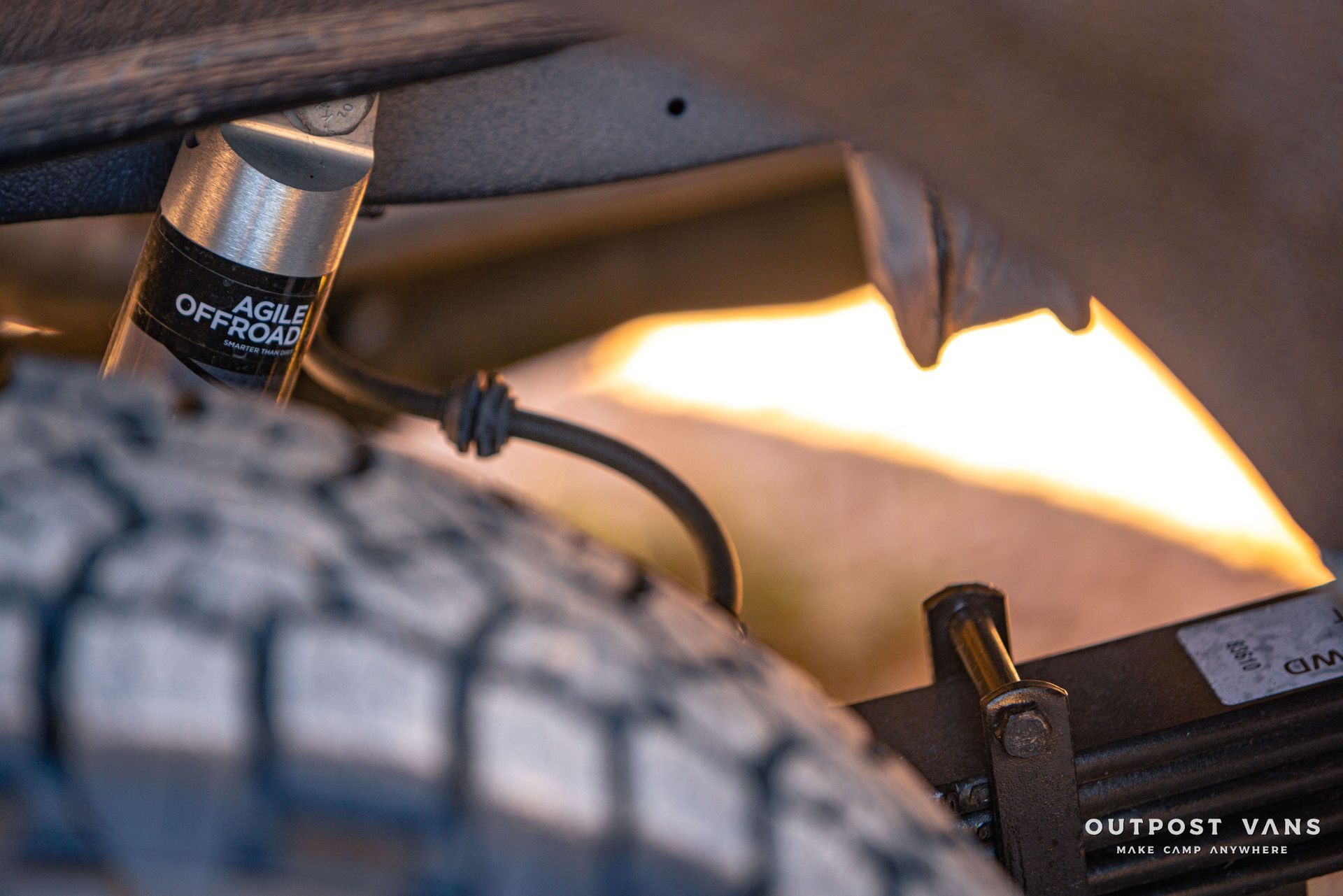 a close up of a shock absorber and a tire on a van .