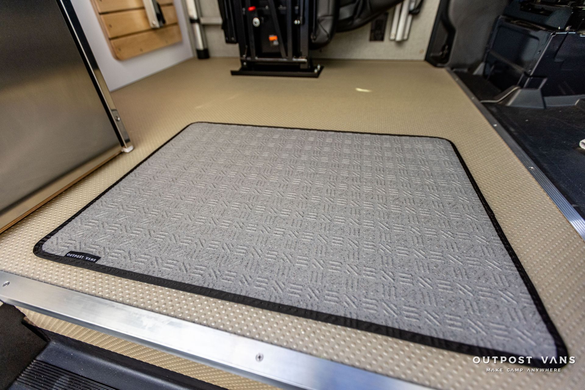 a gray rug is on the floor of a van .