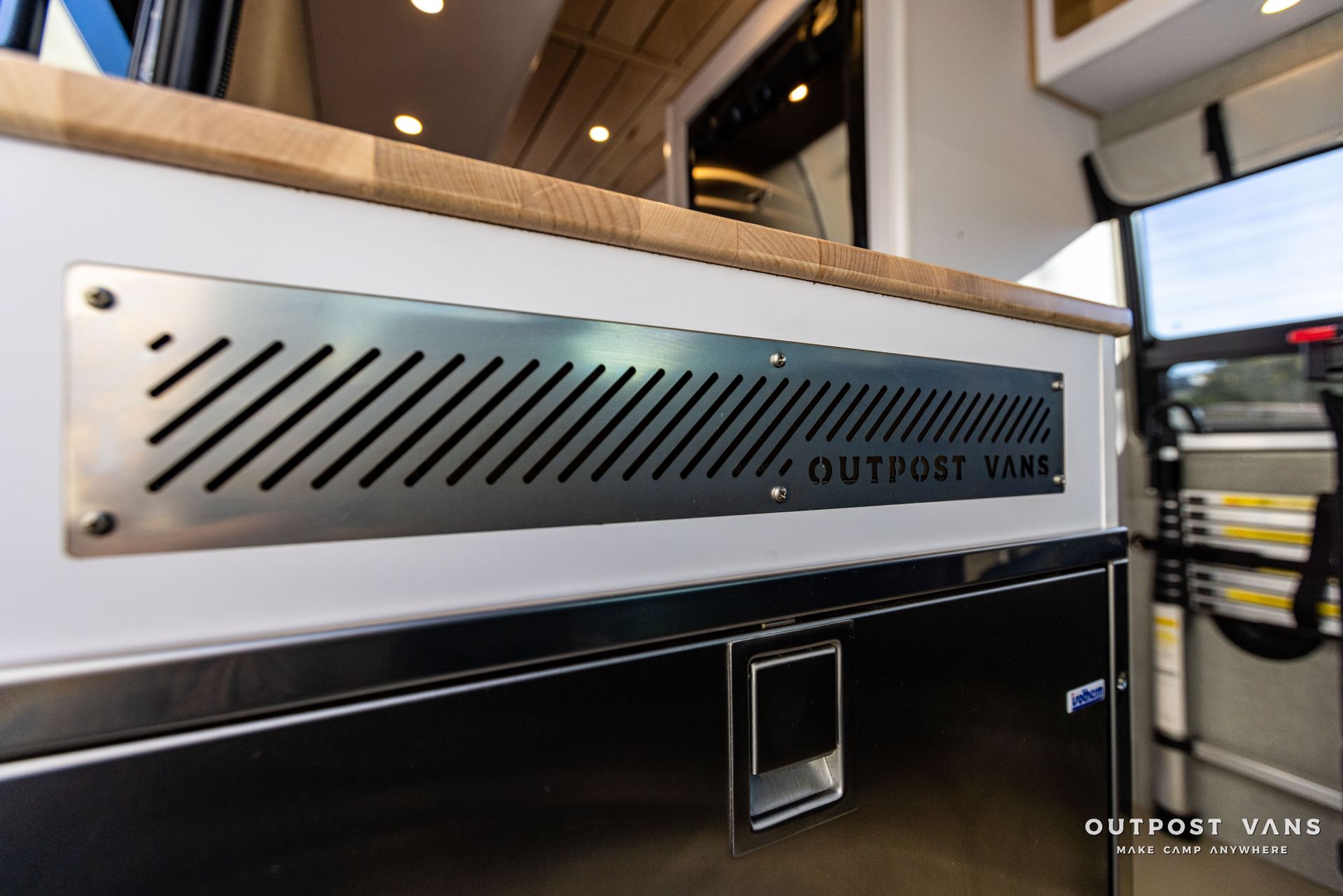 a stainless steel plate with the word outpost on it