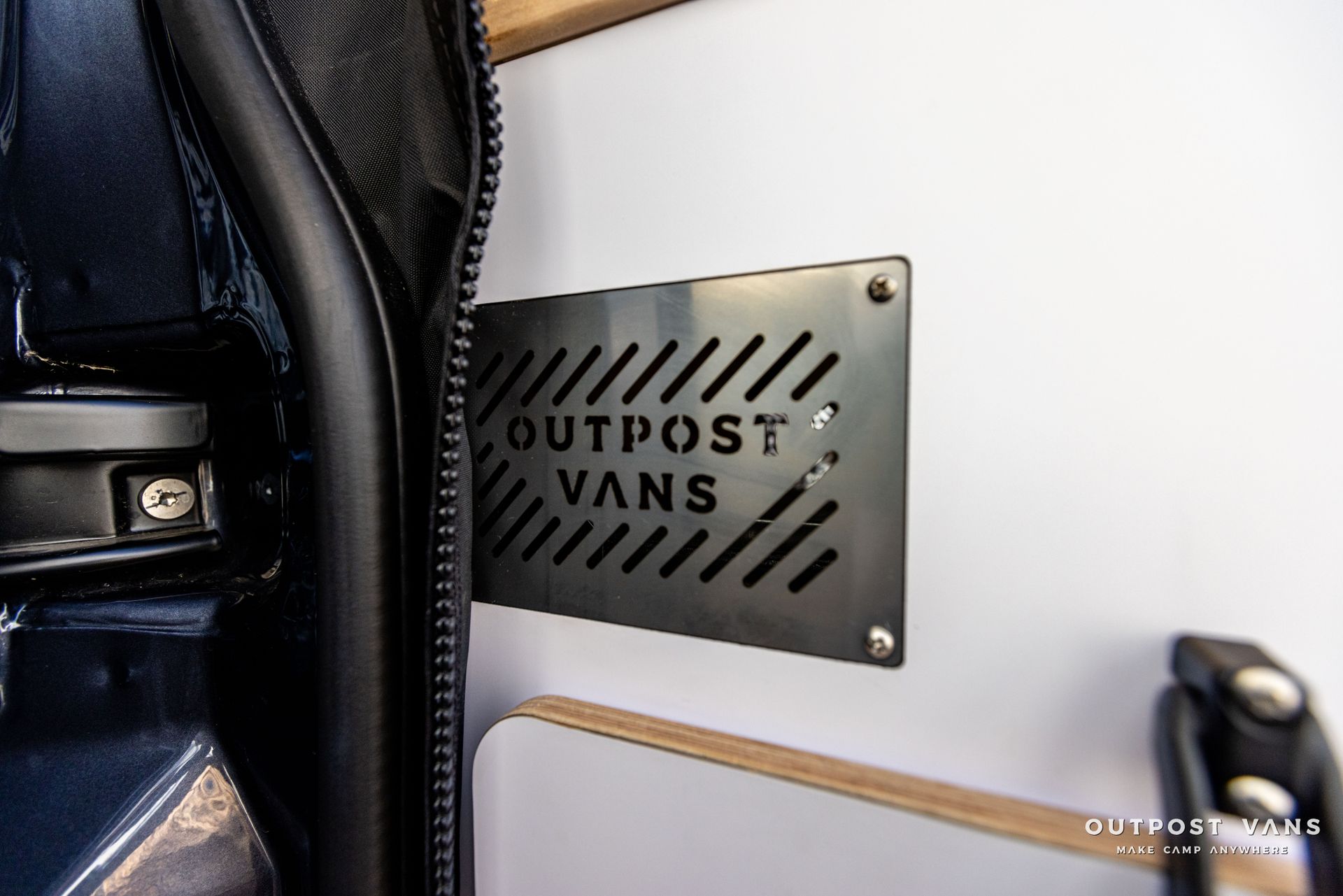 a sign on the side of a van that says outpost vans