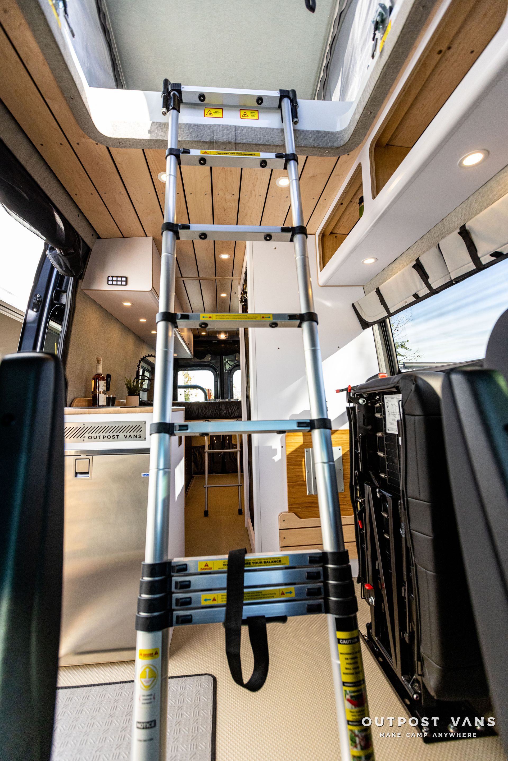 a ladder is hanging from the ceiling of a van .