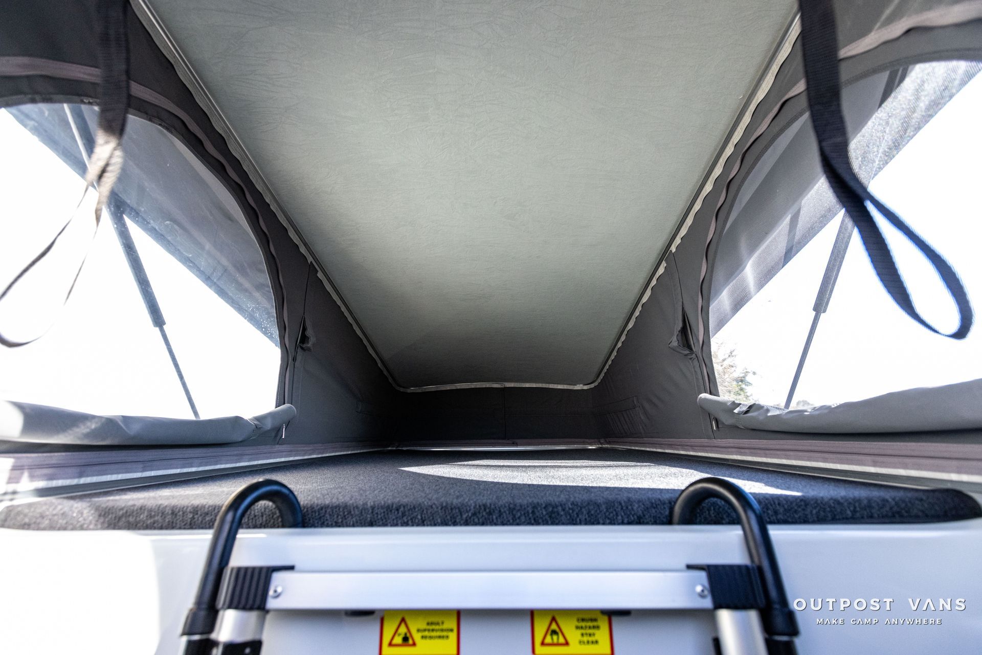 looking up at the ceiling of a camper van with a ladder