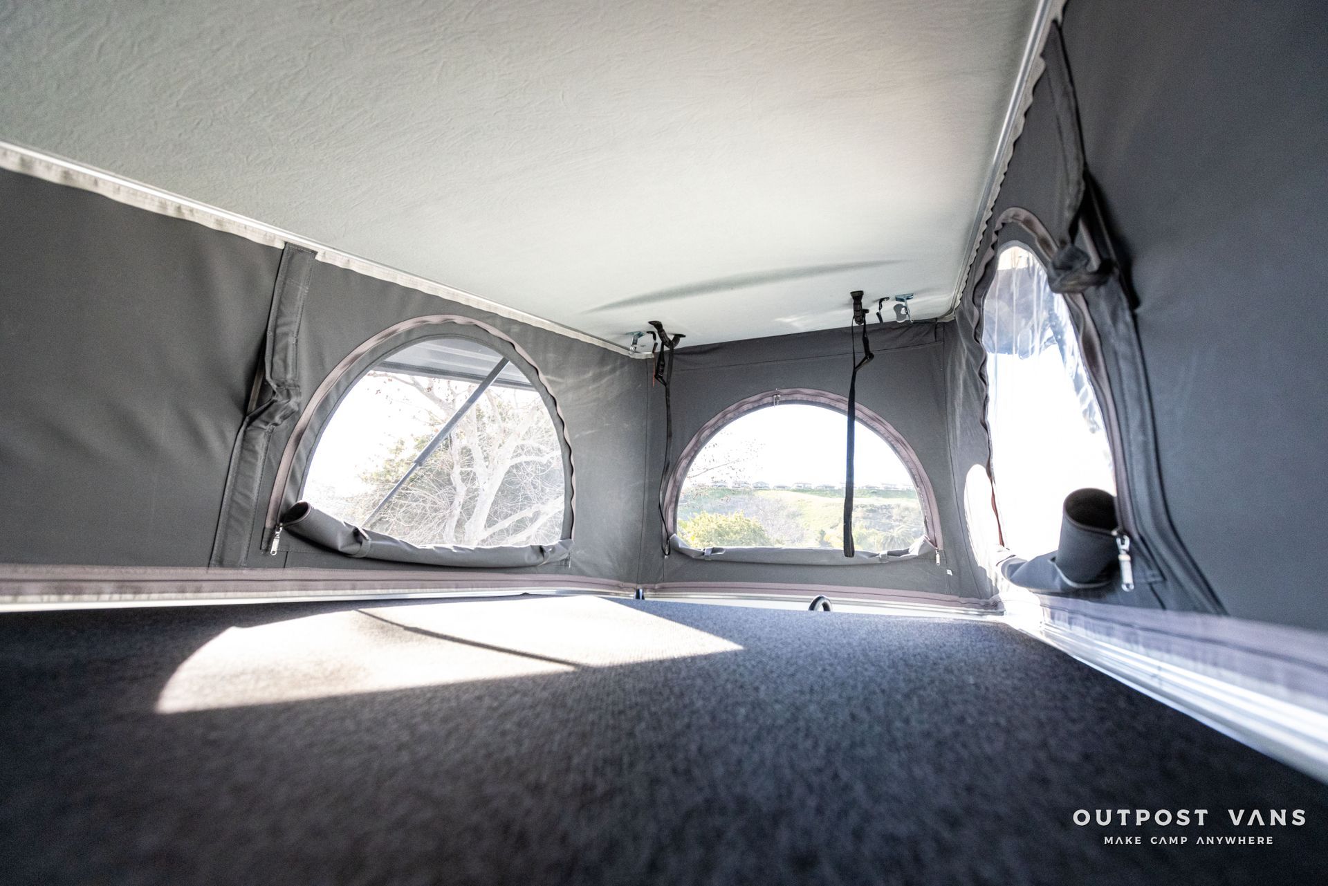 the inside of a van with a tent on top of it .