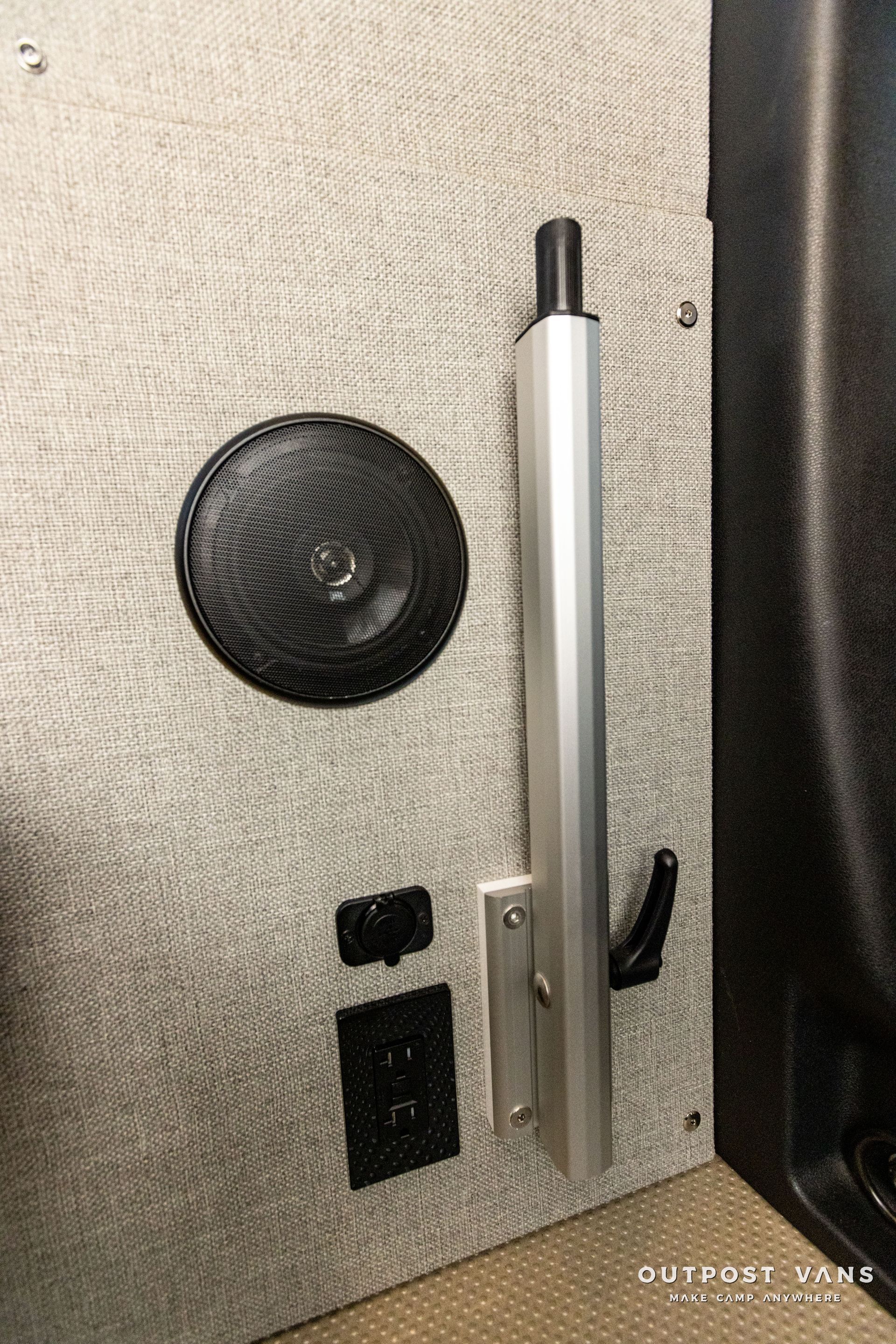 there is a speaker and a socket on the wall .