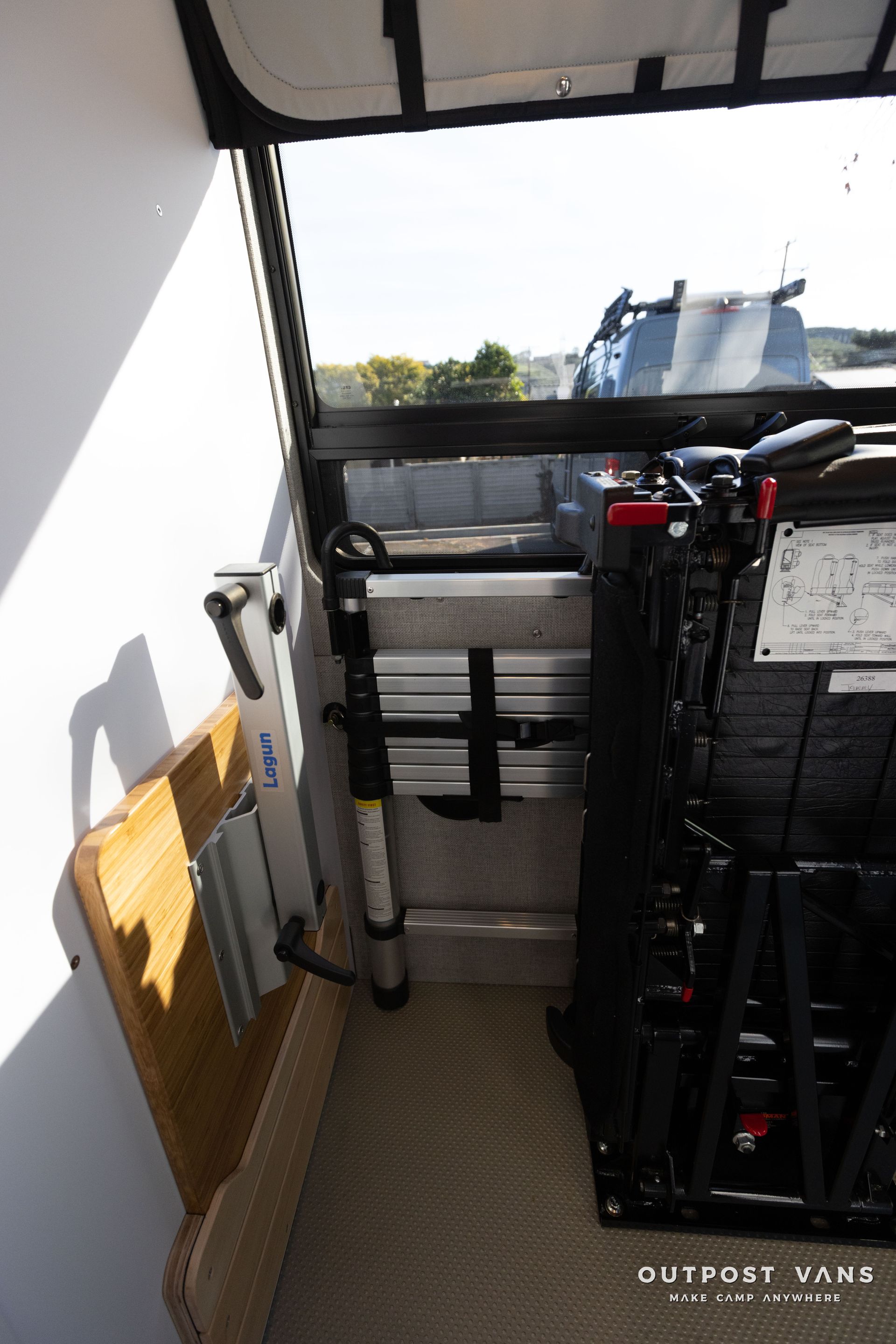 a ladder is attached to the side of a van .