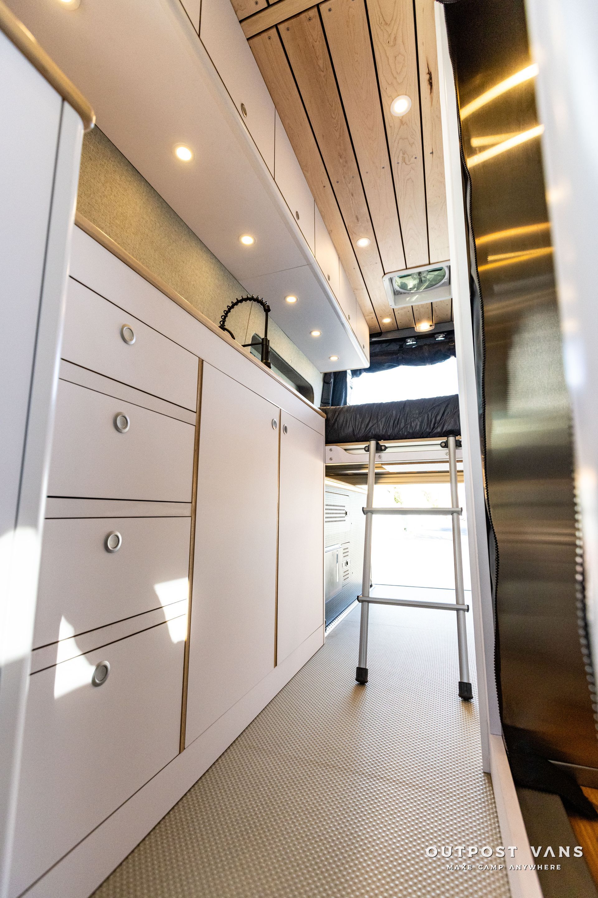 a kitchen with white cabinets and stainless steel appliances .