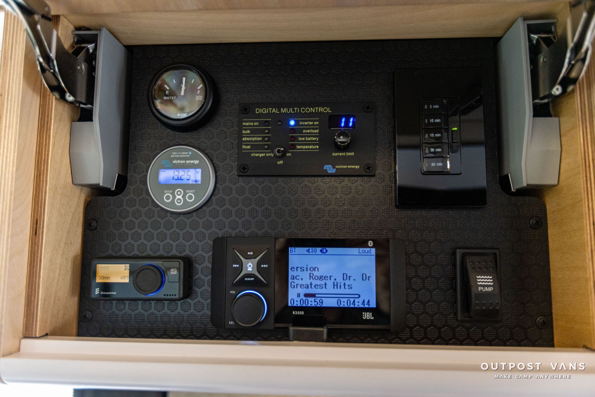a wooden cabinet with a bunch of electronic devices in it