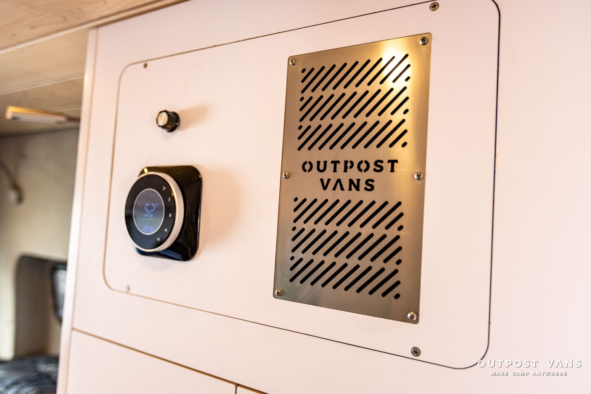 a sign on a wall that says outpost vans on it