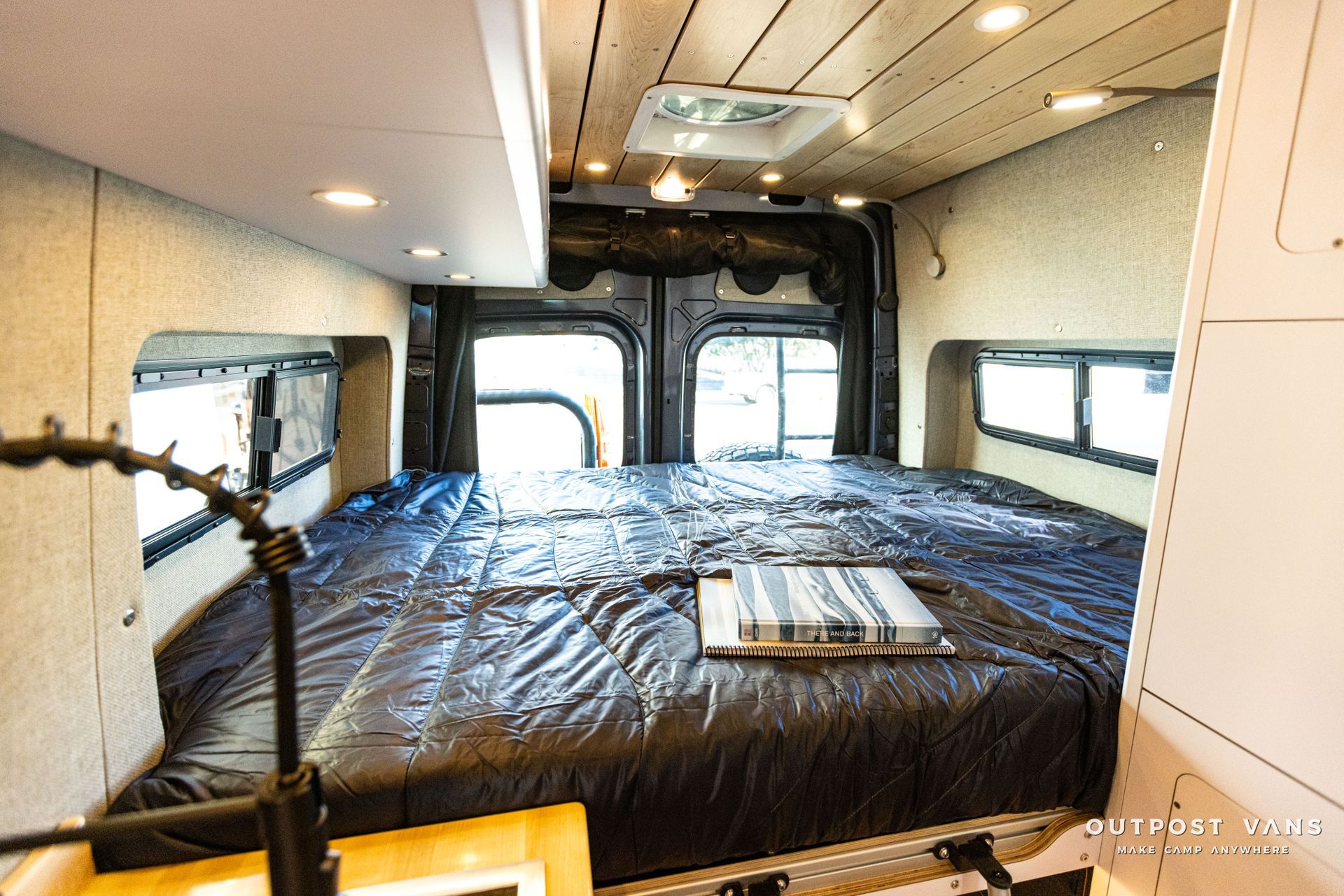 the inside of a van with a bed and a window