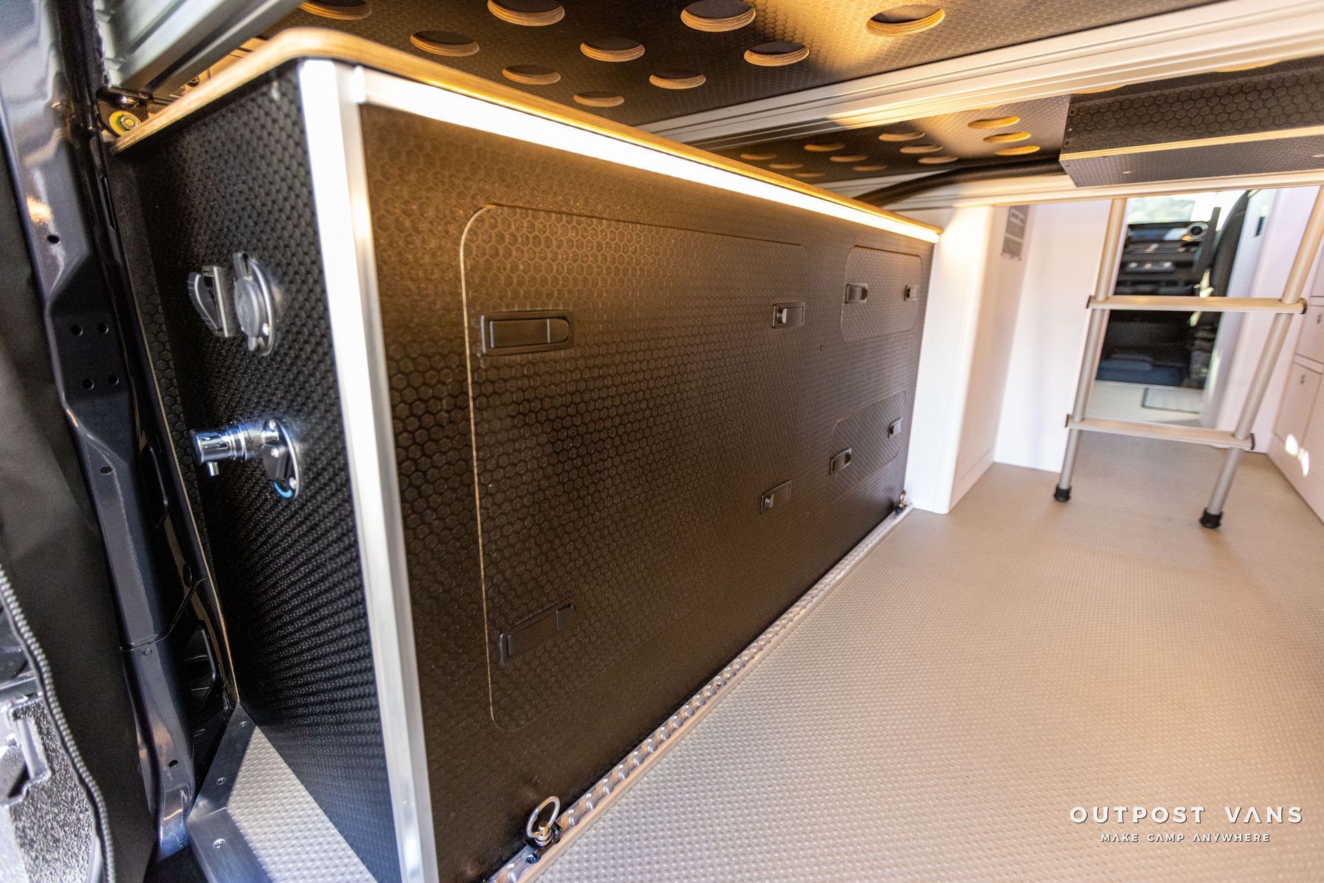 the inside of a van with a ladder in it