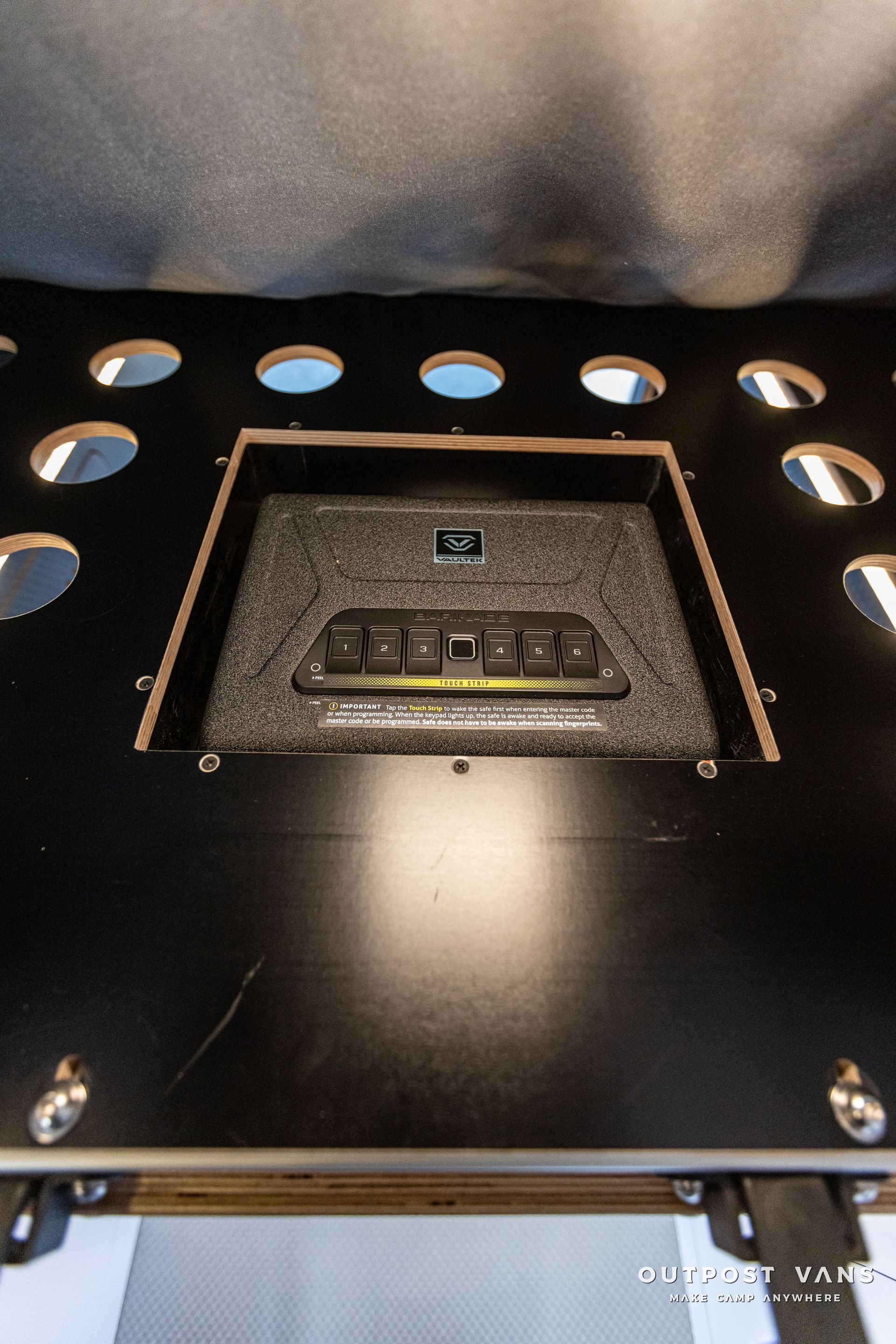 a black box with holes in it is sitting on top of a table .
