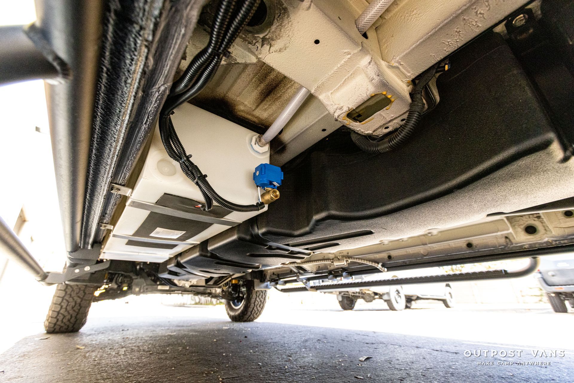 a close up of the underside of a car with a water tank attached to it .