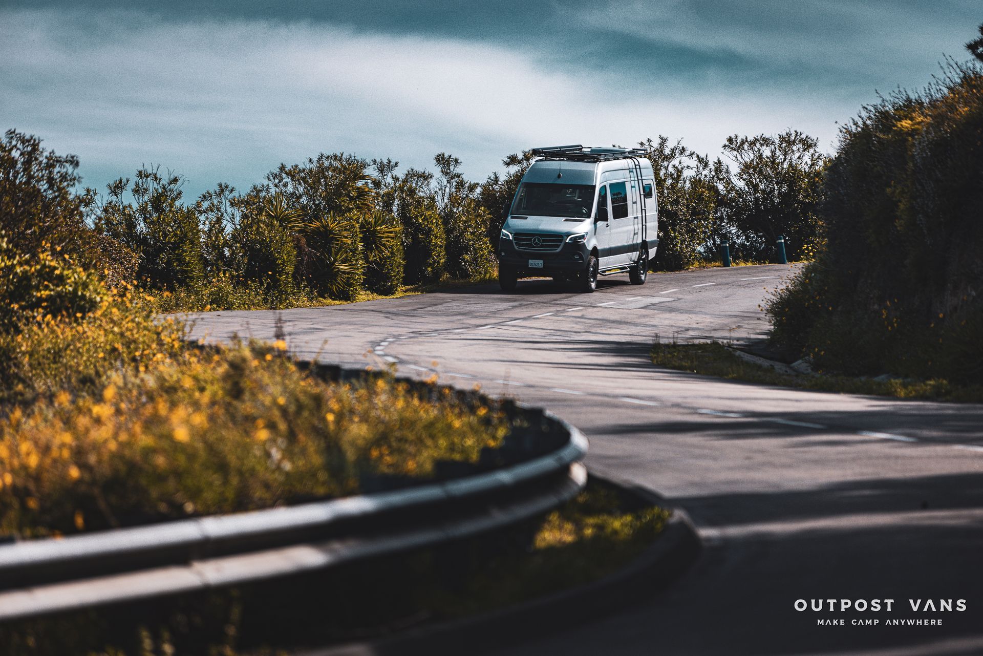 a white van is driving down a curvy road
