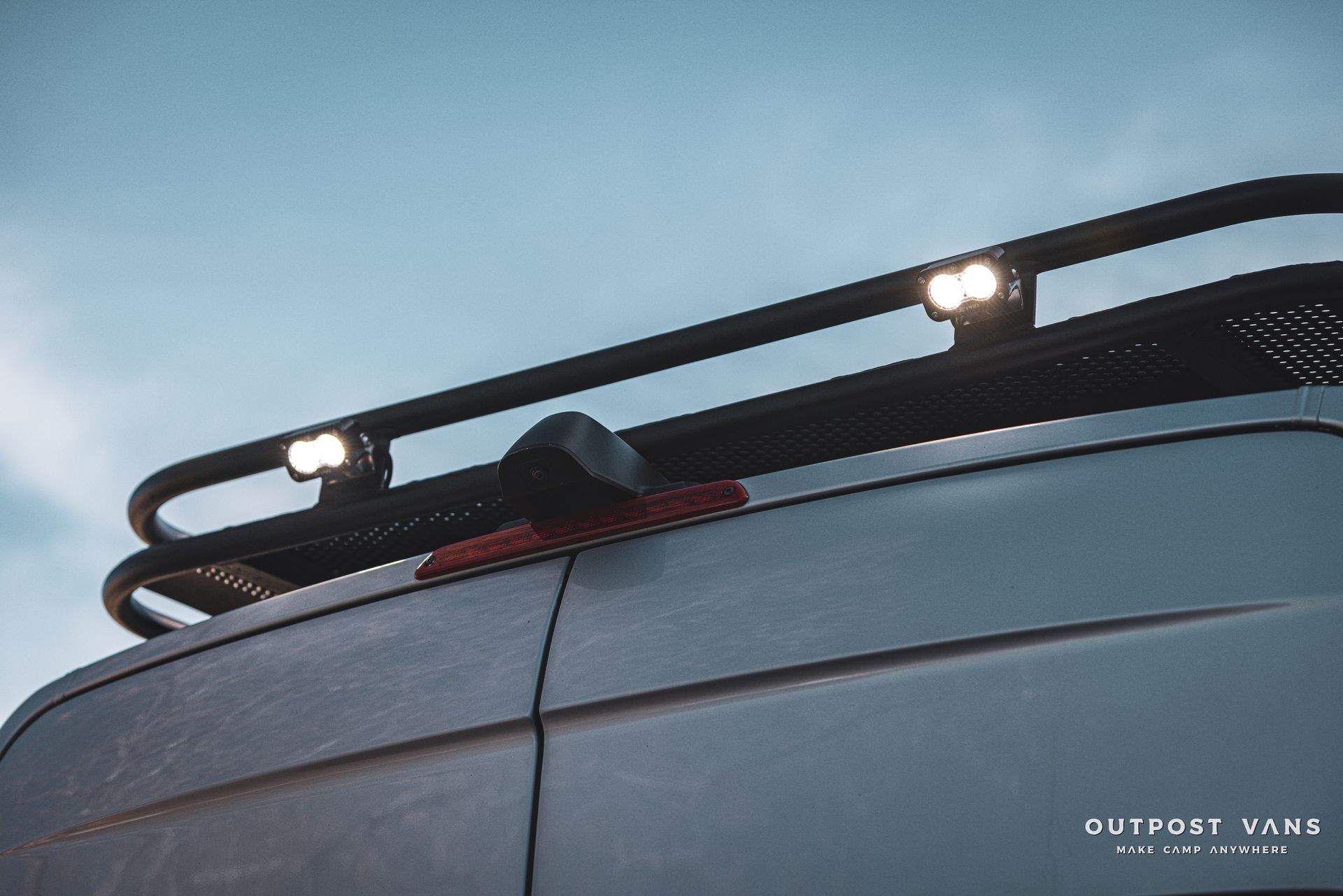 a van with a roof rack and lights on it .