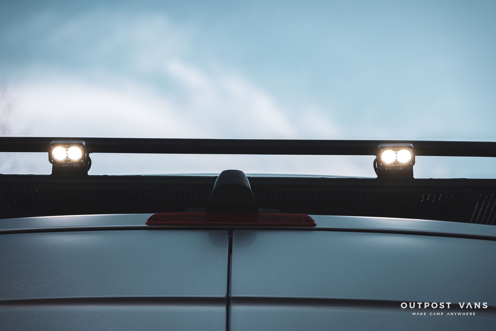a white van with a roof rack and lights on it