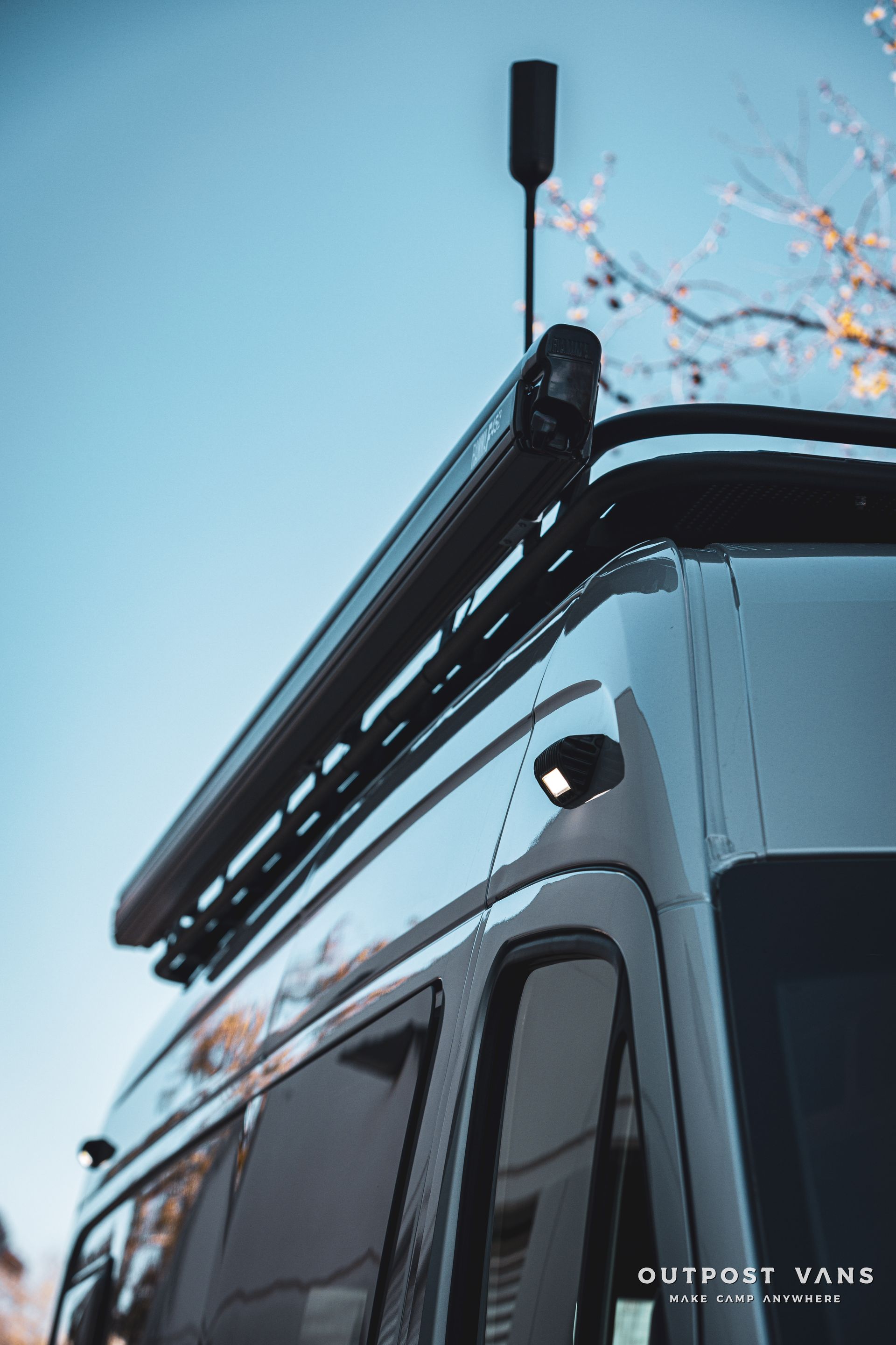 a van with a roof rack and antenna on top of it .