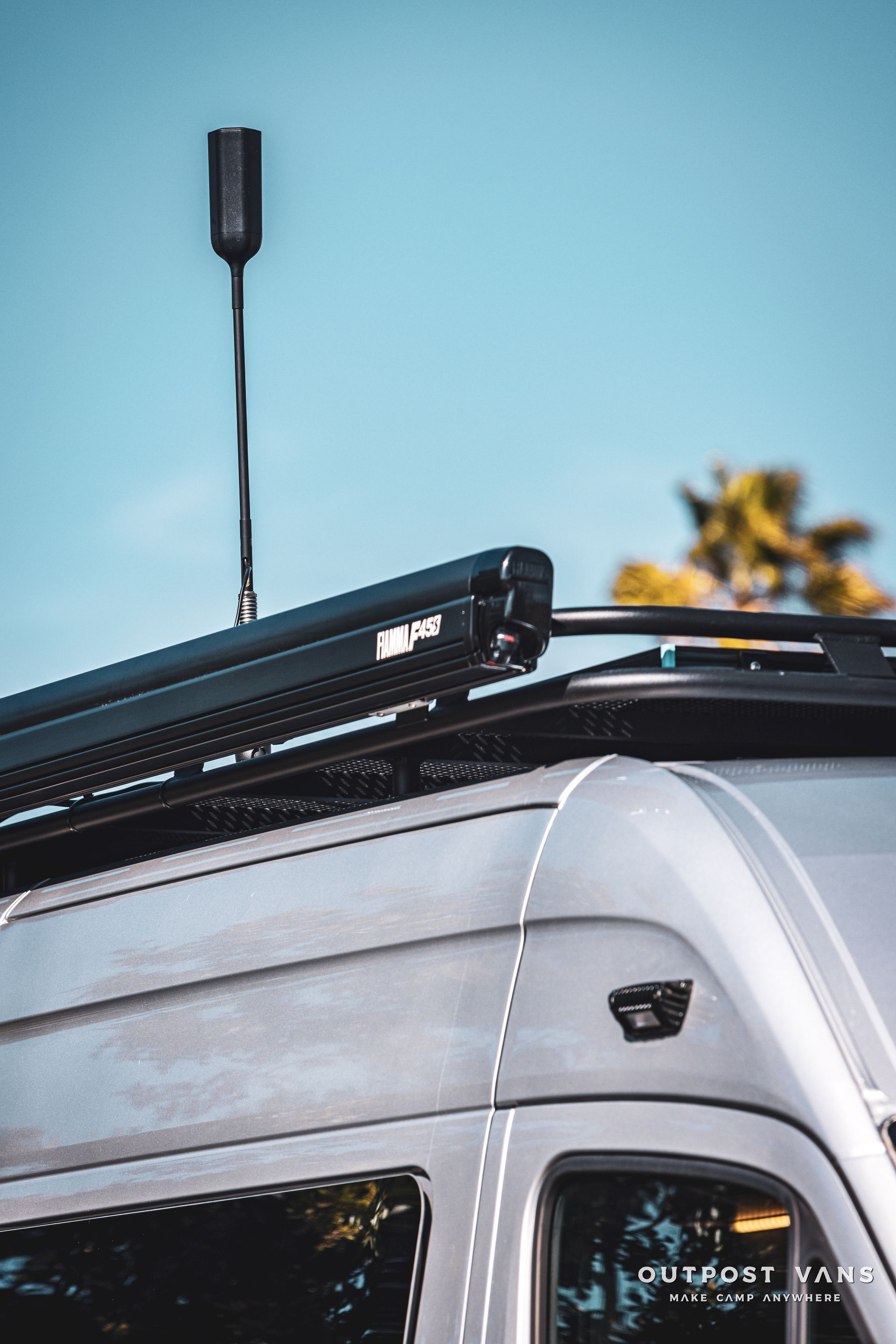 a van with a roof rack and antenna on top of it .