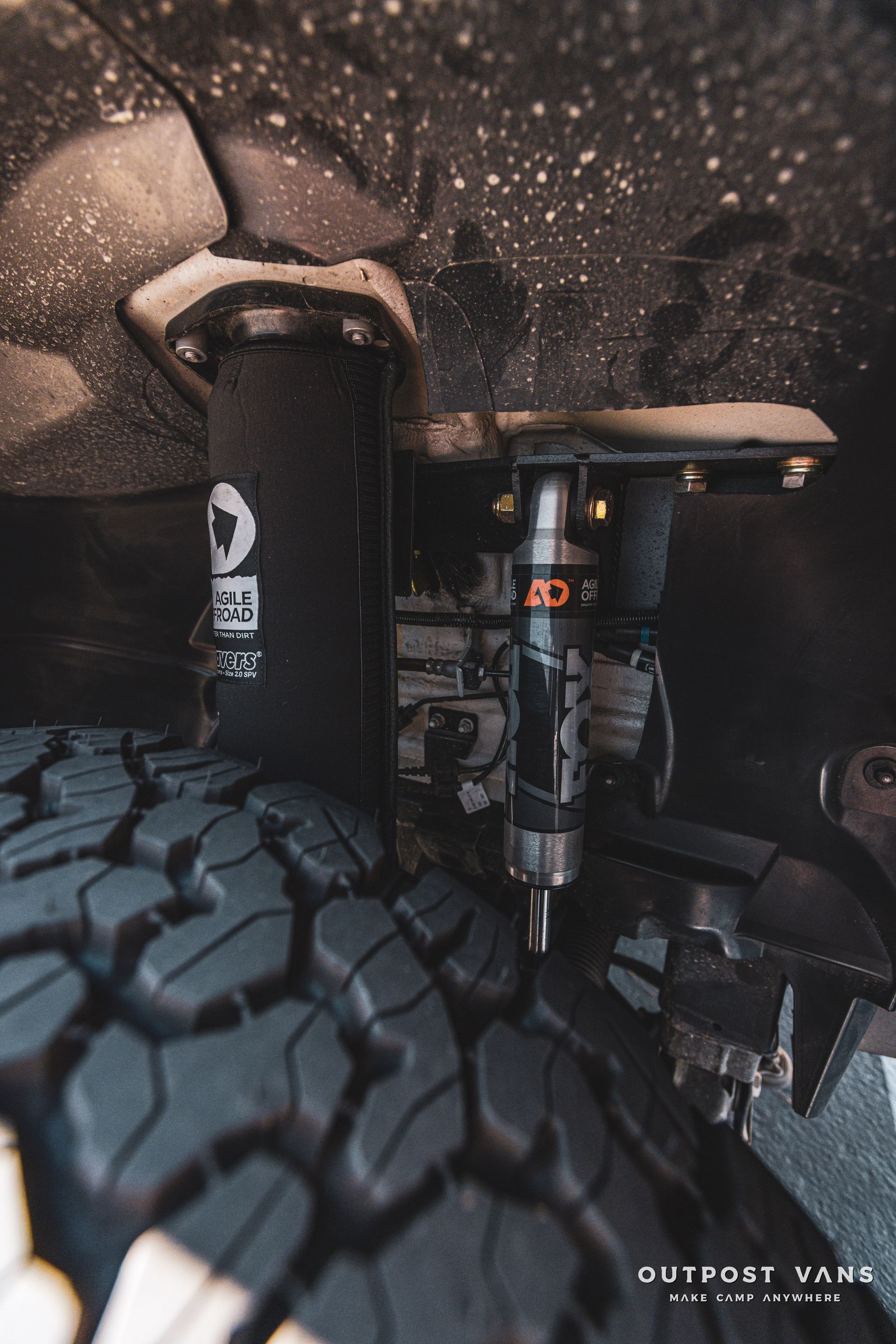 a close up of a shock absorber and a tire on a truck .
